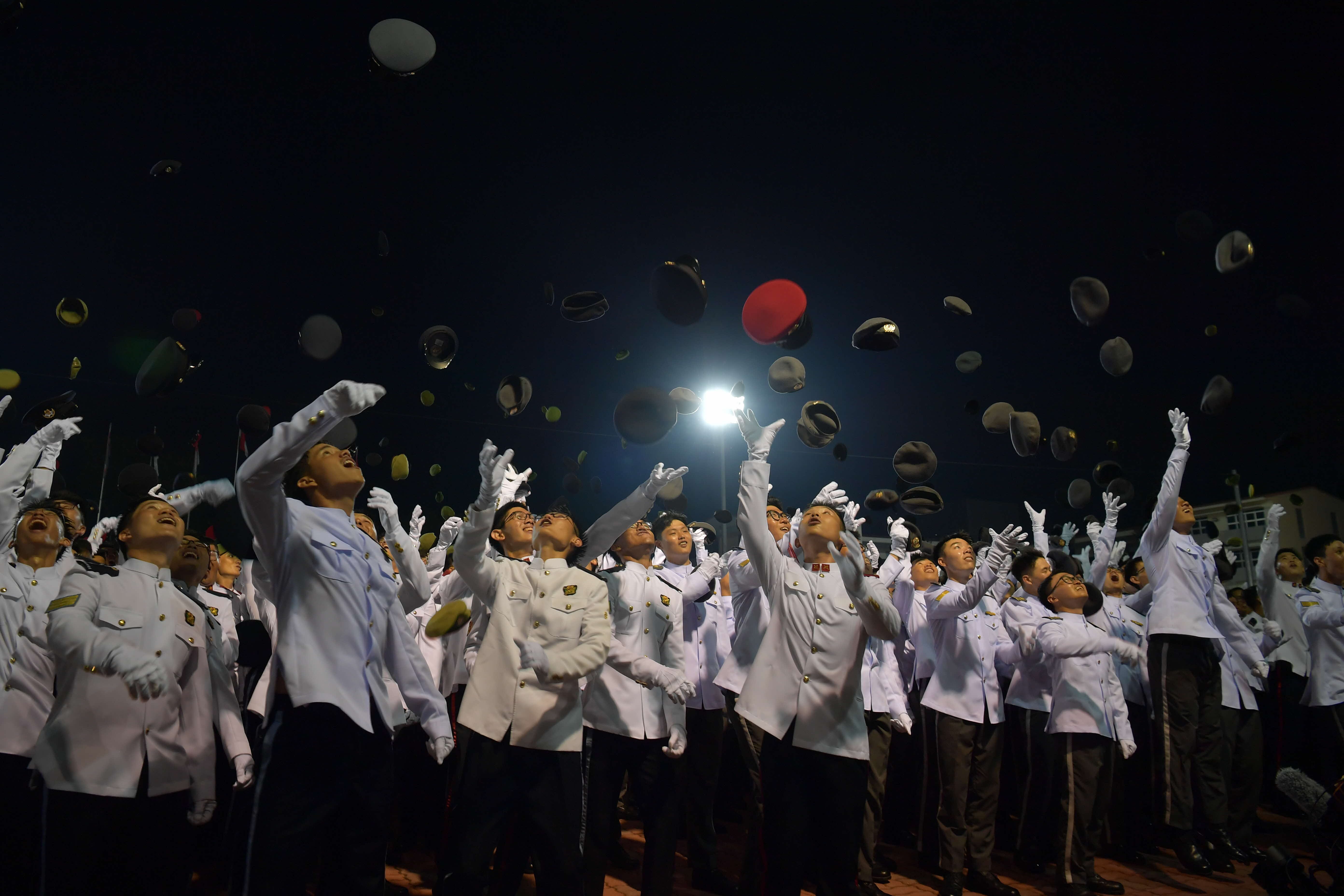 The Specialists and Military Experts tossing their headdresses at the end of the parade.