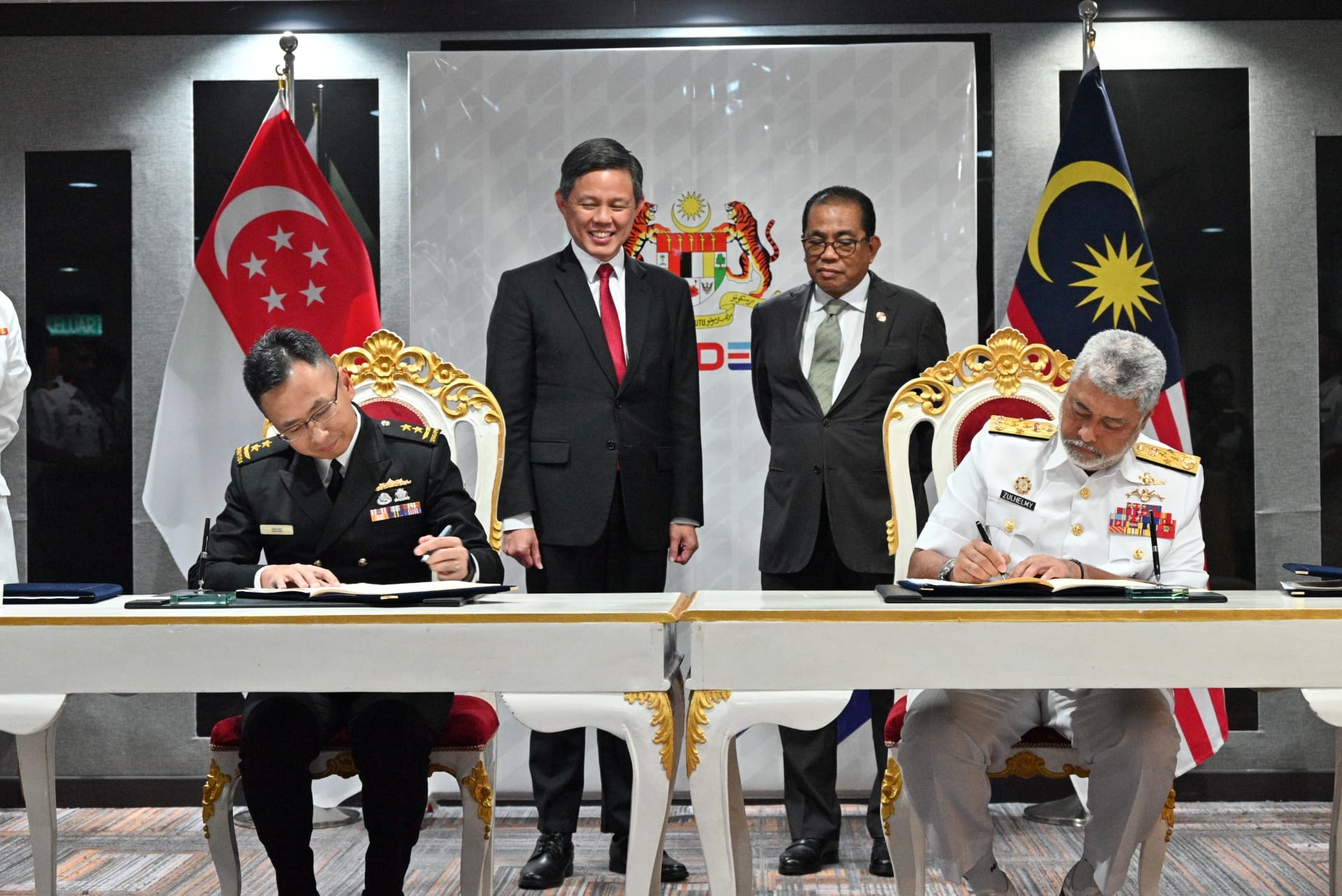 Singapore Chief of Navy Rear Admiral (RADM) Sean Wat (far left) signing the Arrangement for Mutual Submarine Rescue....