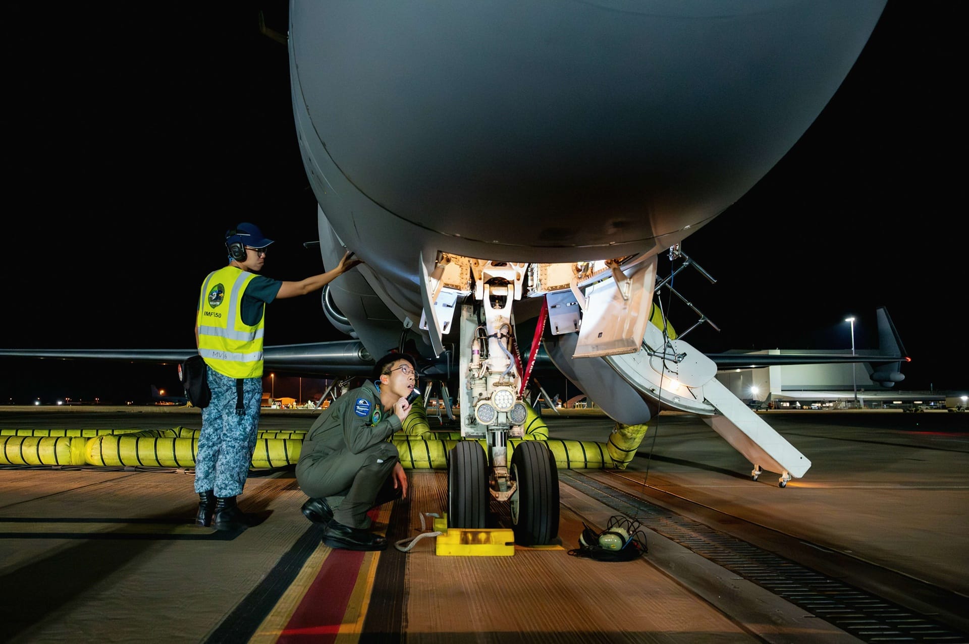 Personnel conducting pre-flight checks on the G550 Airborne Early Warning aircraft that provides persistent ability to detect, identify and track aerial targets.