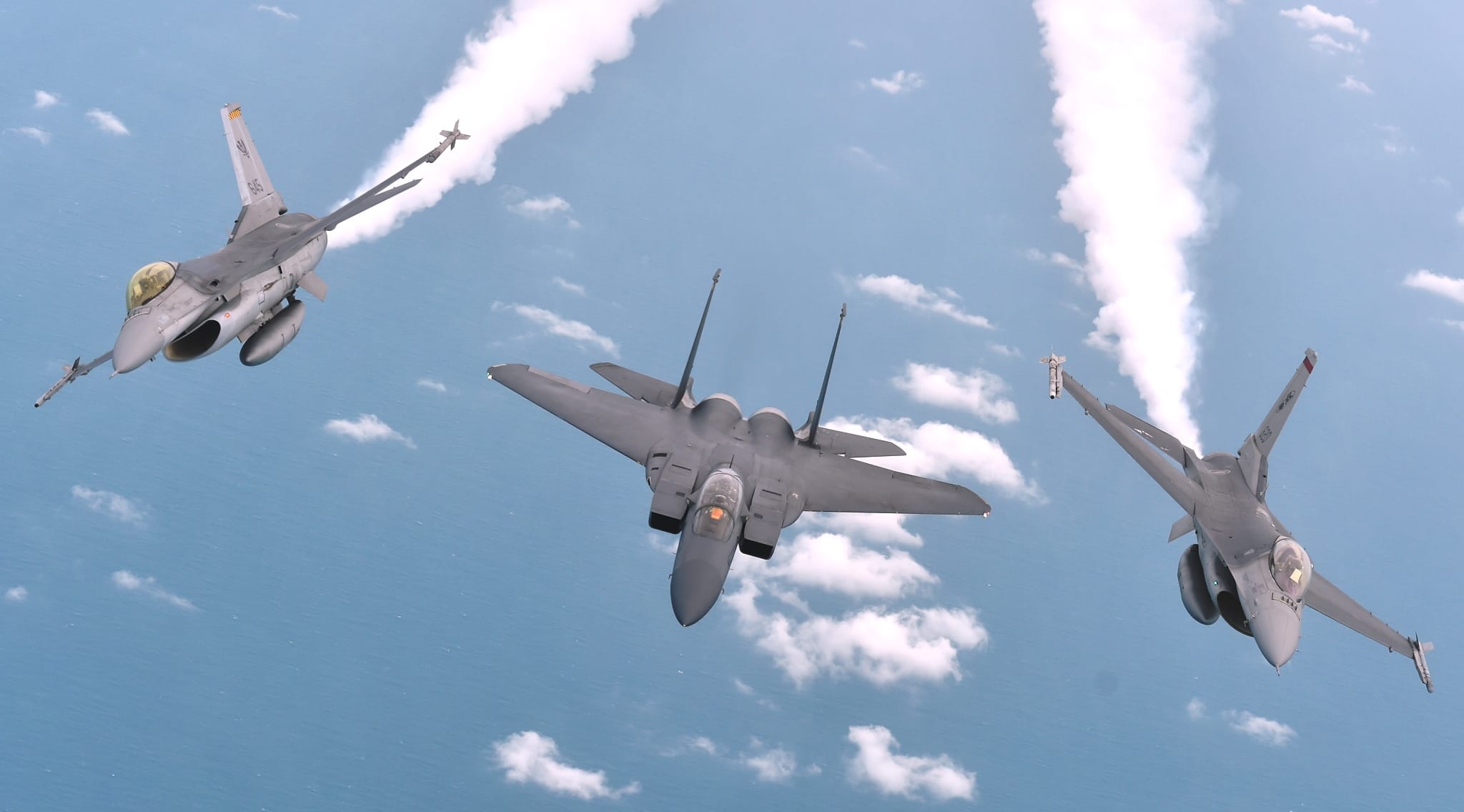 A Republic of Singapore Air Force (RSAF) F-15SG and two F-16s demonstrating an aerial manoeuvre as part of the RSAF50 Media Conference.