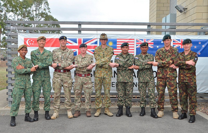 SAF delegation leader LTC Joseph Lin (second from left) and delegation sergeant major 3rd Warrant Officer Suffian Bin Amin (far left) joining hands with representatives of the other FPDA nations at Exercise Suman Warrior 2013.