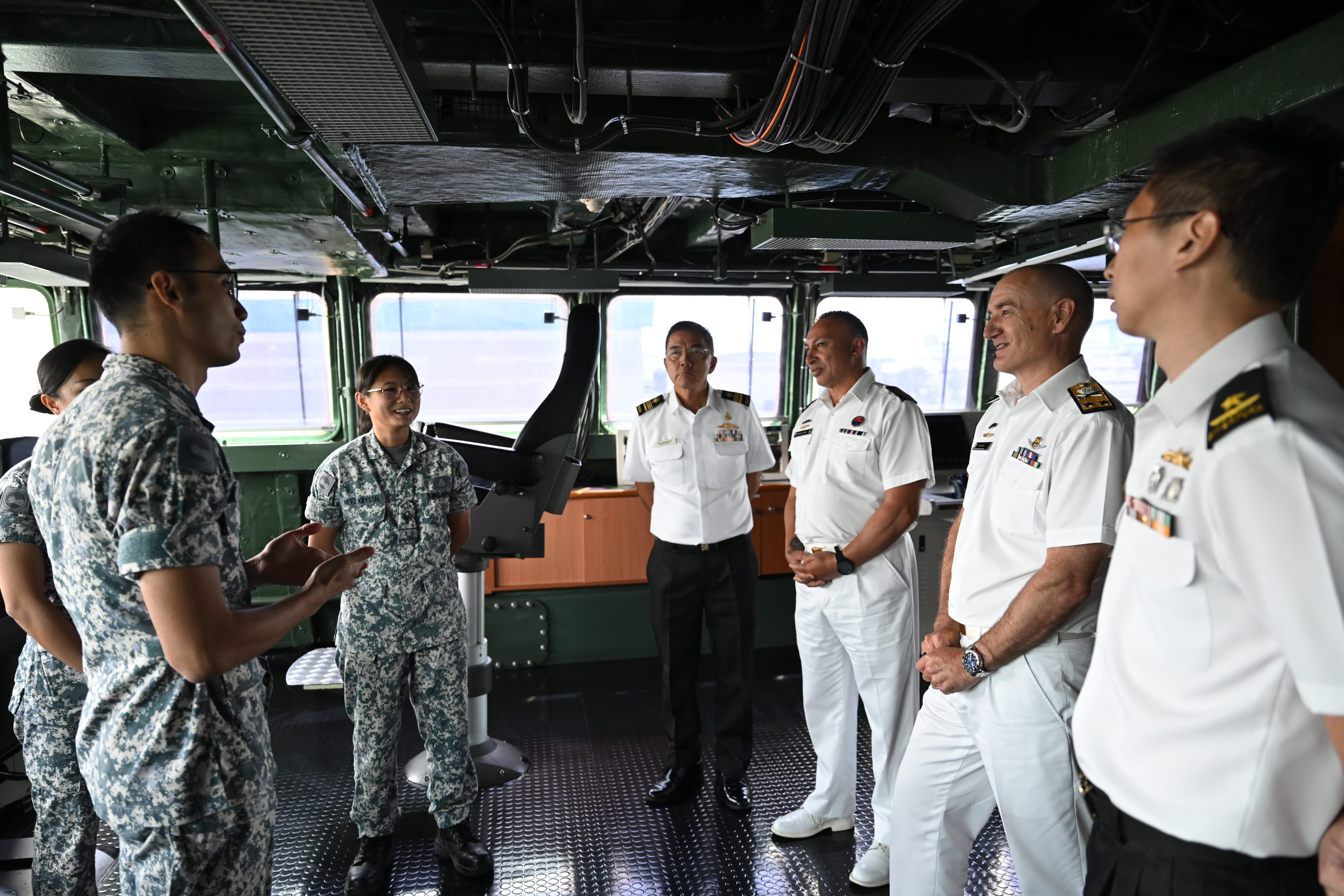 RADM Golding receiving a brief on the Formidable-class frigate during his visit on board RSS Tenacious.