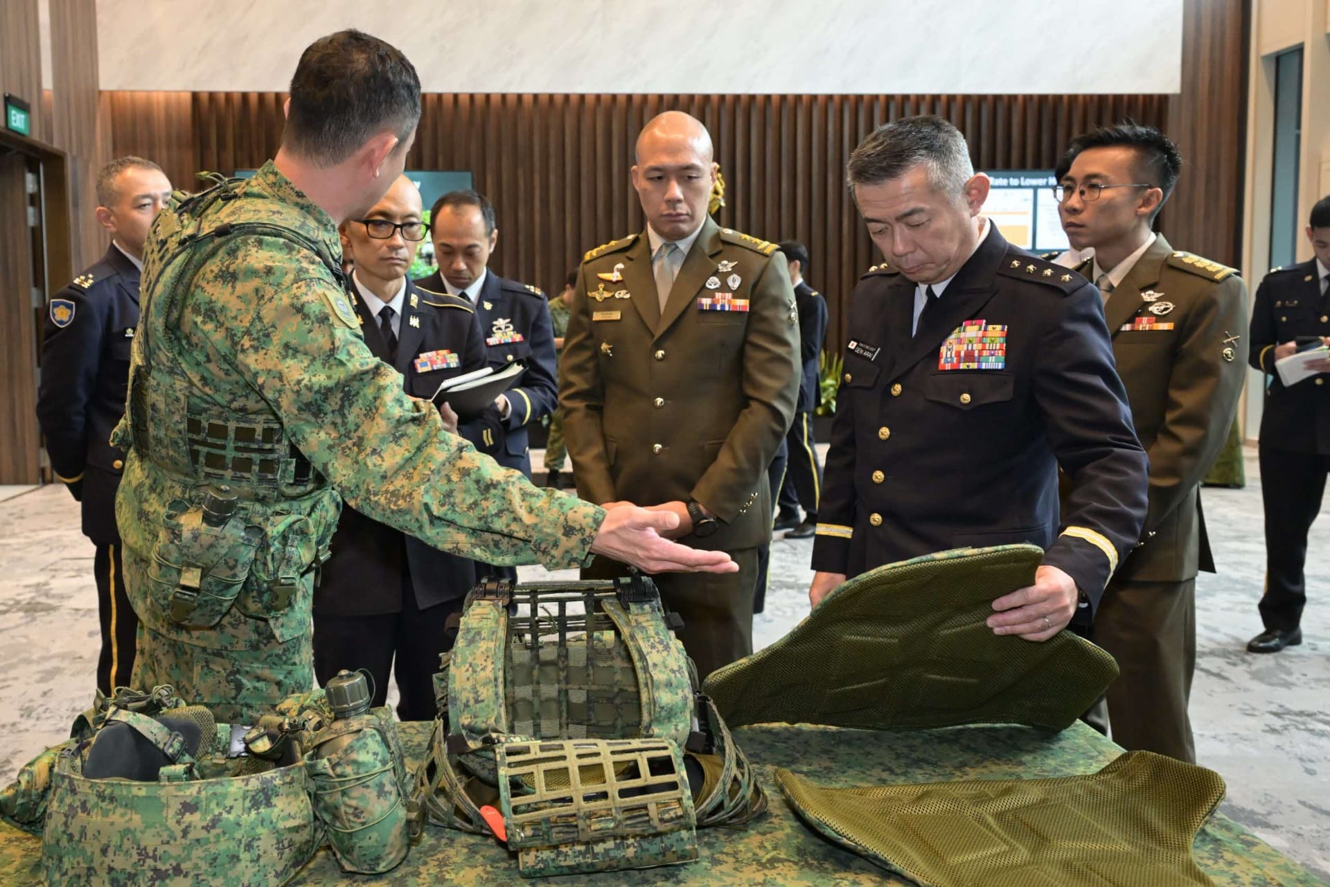 GEN Arai viewing a static display of equipment and systems at MINDEF, hosted by the Centre of Excellence for Soldier Per