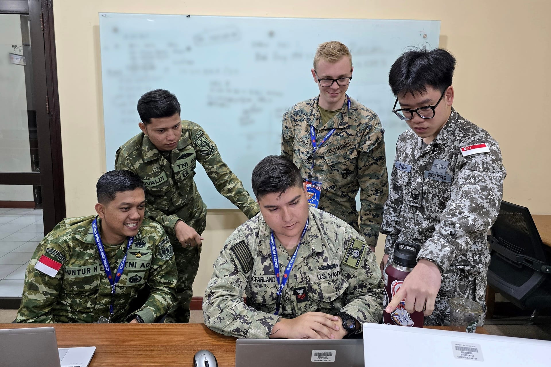 A member of the Singapore Army in a small group discussion with his counterparts during the Joint Staff Exercise segment of Exercise Super Garuda Shield (XSGS).