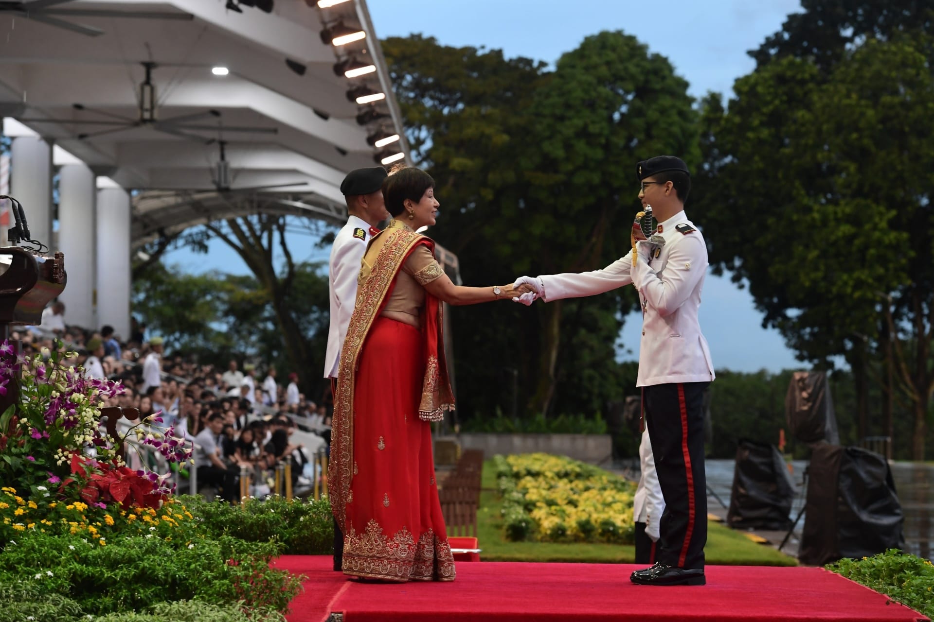 Ms Indranee Rajah presenting the Sword of Honour to Second Lieutenant (2LT) Joseph Tan Qi En from the Singapore Army.
