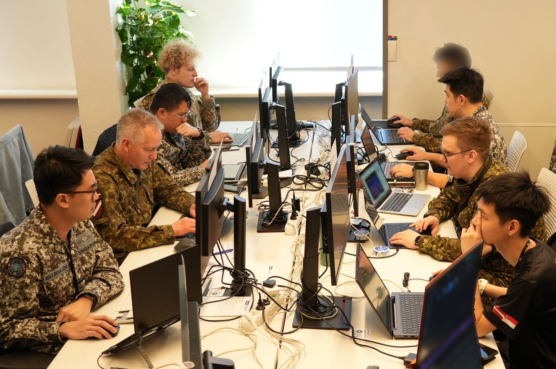 The joint Latvia-Singapore team participating in Exercise Locked Shields 2026, a multinational cyber defence exercise.