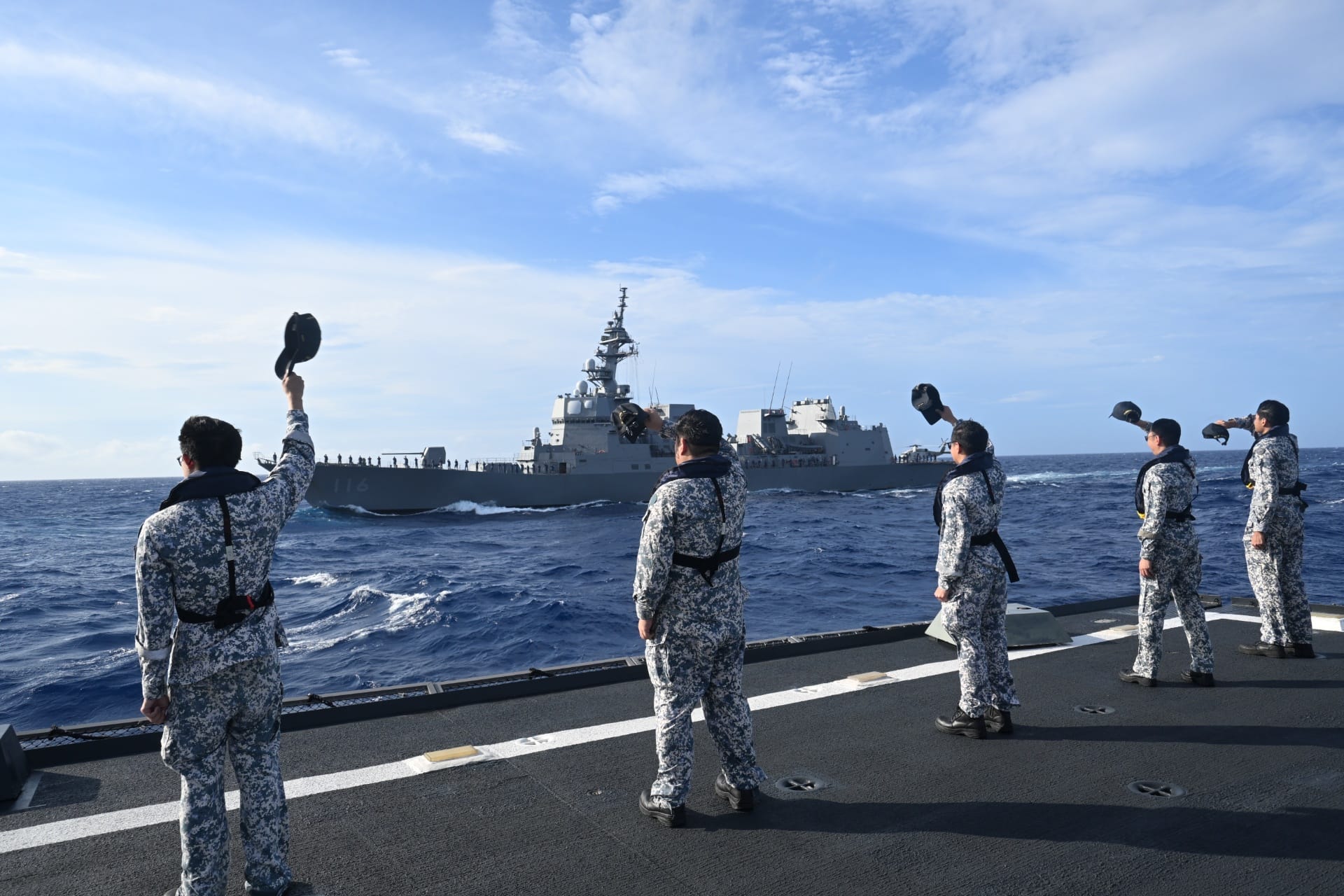 The Republic of Singapore Navy (RSN) personnel taking part in the exercise's closing ceremony via a sailpast at sea.