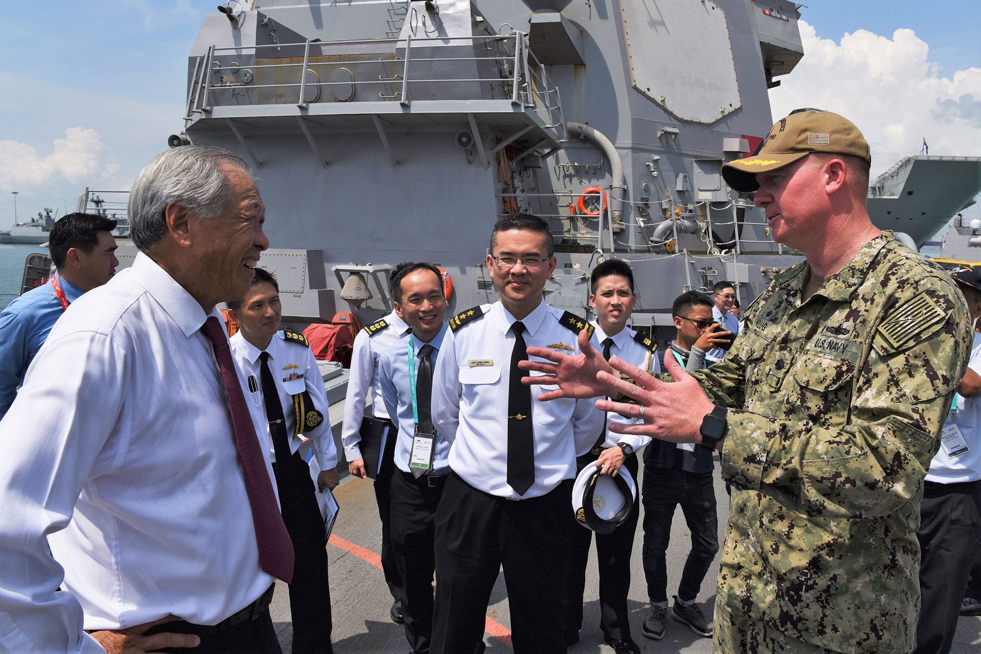 Dr Ng receiving a brief from Commander Andrew Klug, Commanding Officer of the United States Navy ship USS William P. Lawrence.