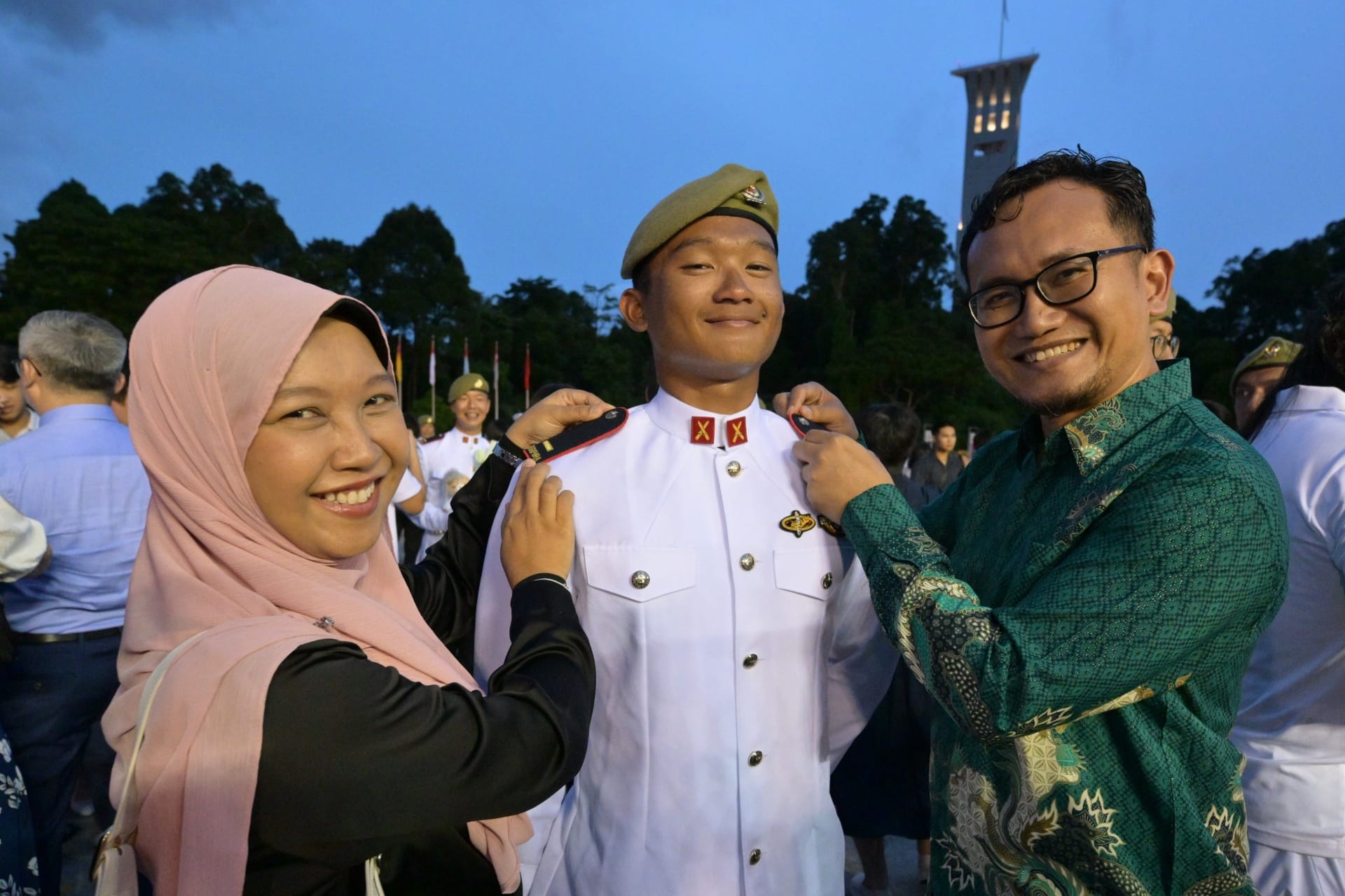 Second Lieutenant (2LT) Zulfikri Bin Zul’Irfan’s family member affixing the officer-rank epaulettes on him.
