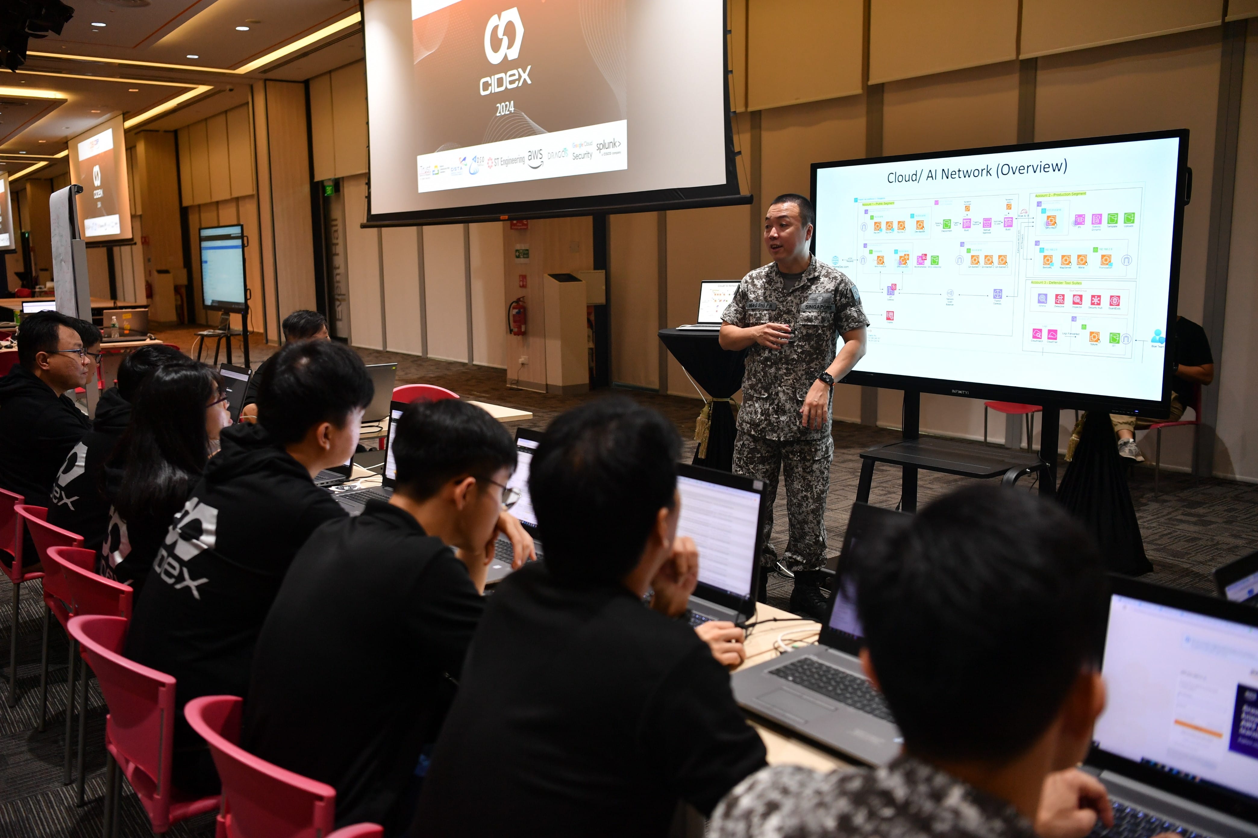 Participants from the Critical Infrastructure Defence Exercise (CIDeX) 2024 partaking in exercise-based scenarios to defend their digital infrastructure against live simulated cyberattacks.