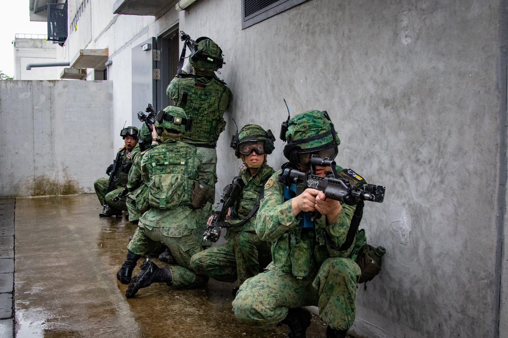 Soldiers from the Singapore Army executing an integrated urban operations mission at SAFTI City.