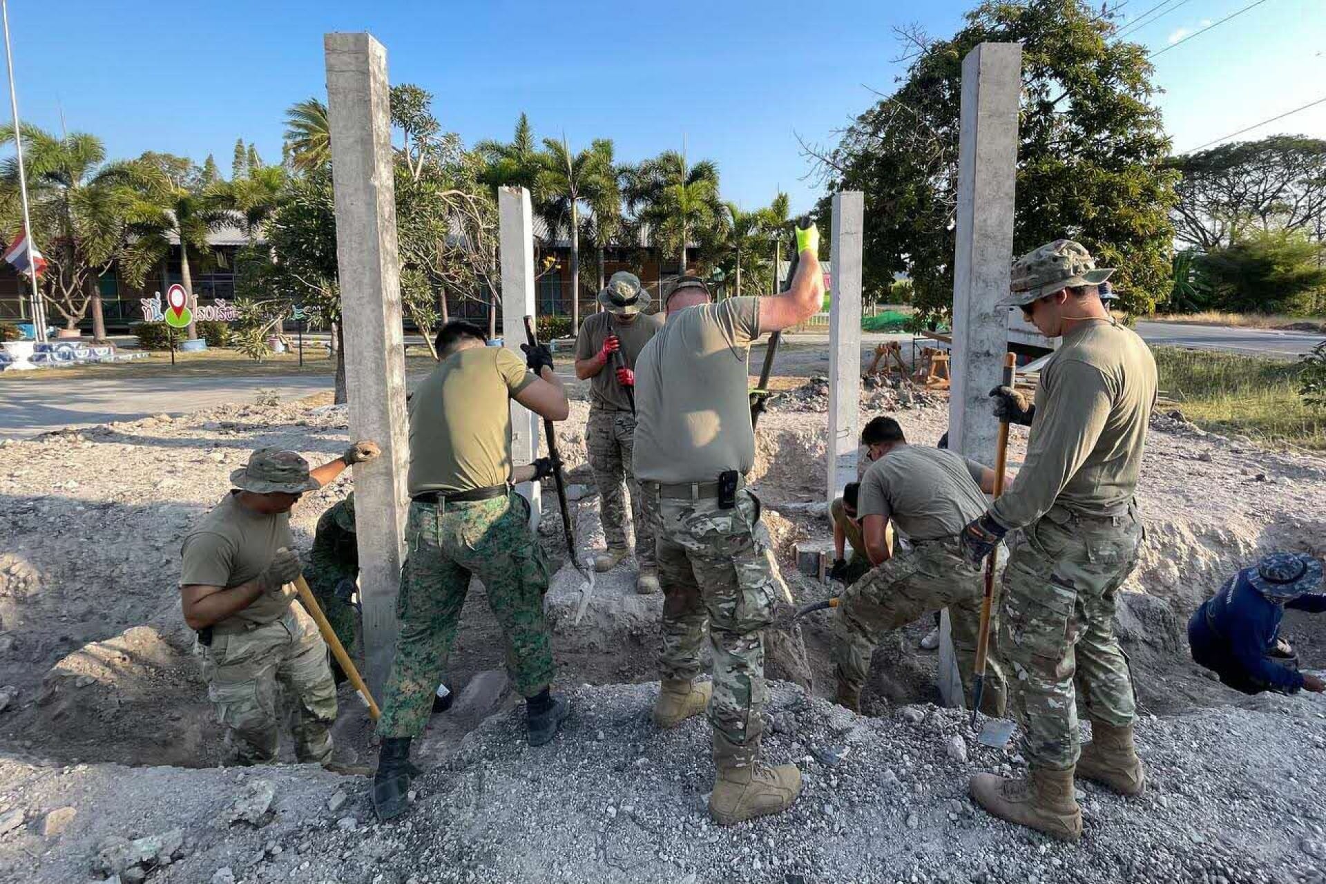 XCG25 participants working together to construct a multi-purpose building for Ban Dong Marum School as part of the Engineer Civic Assistance Programme (ENCAP).
