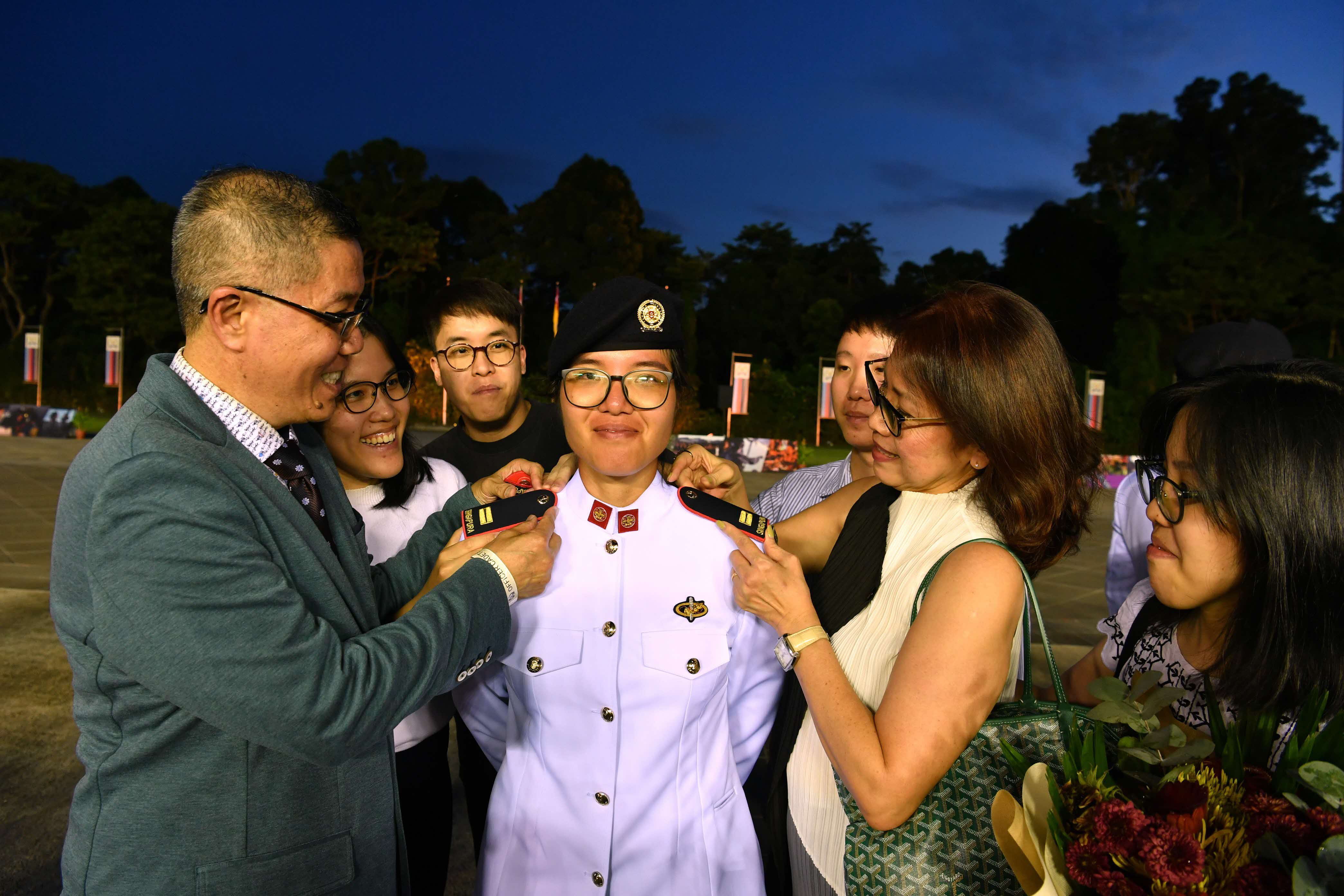 LTA Annabelle Chin's parents affixed the officer-rank epaulettes on her.