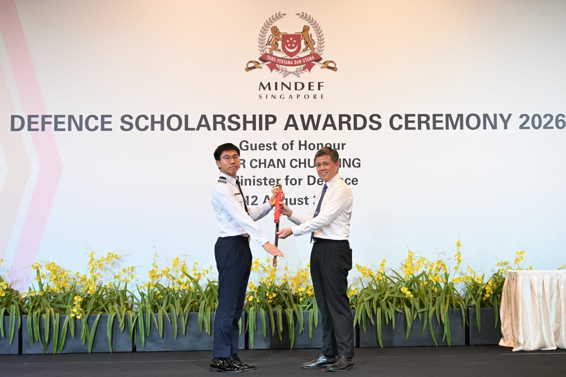 Minister Chan presenting OCT Tristan Lock Chun Yu with The Singapore Armed Forces Scholarship.