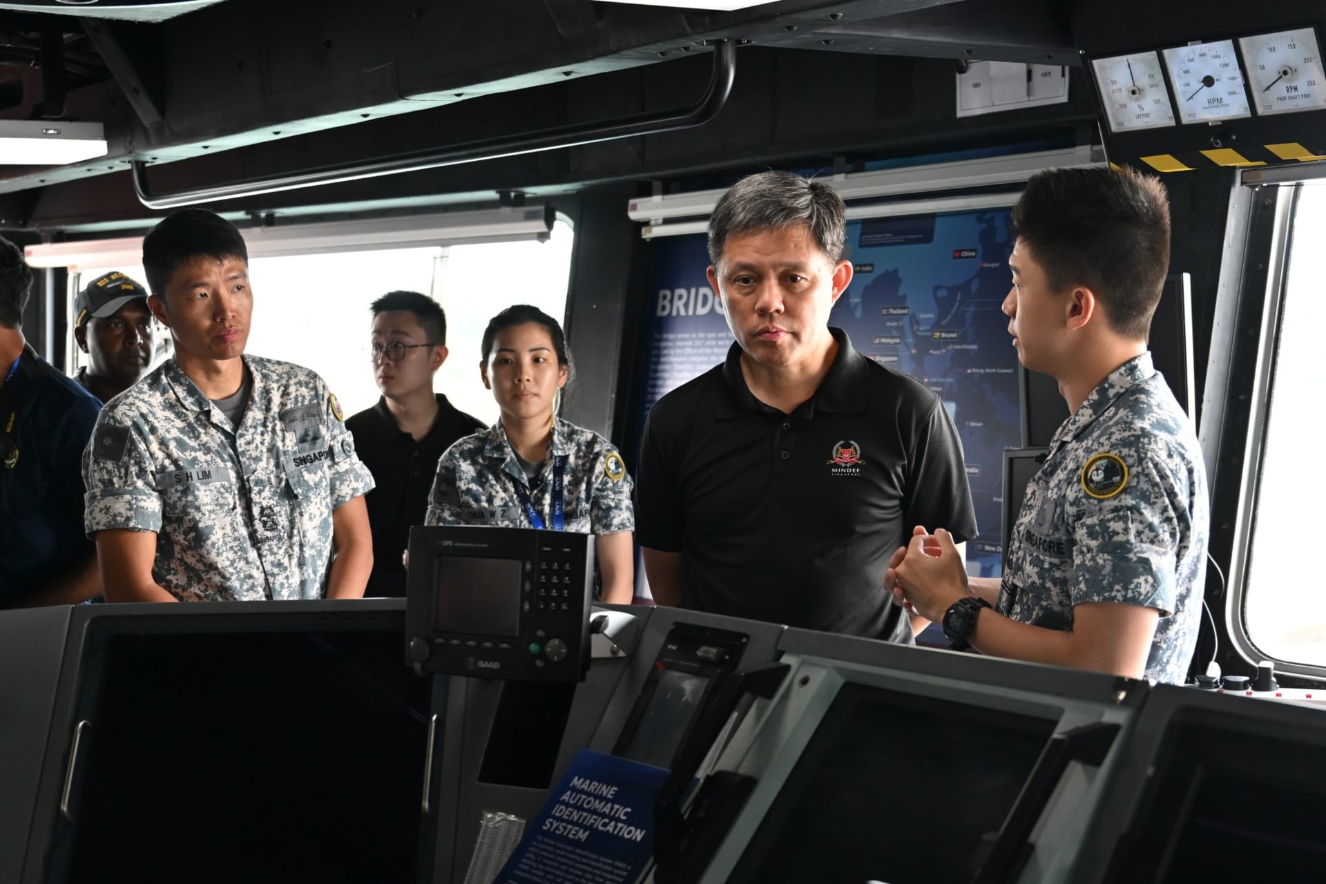 Mr Chan receiving a brief on board the bridge of RSS Resolution during the ship tour.