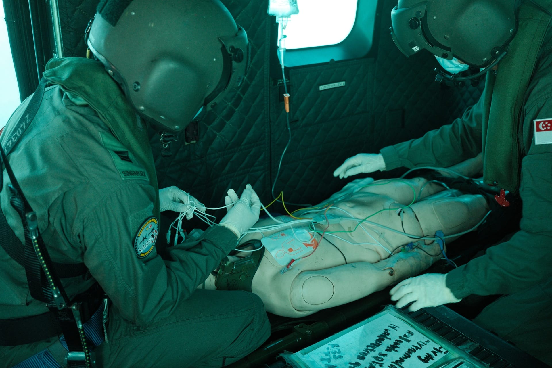 RSAF medical crew providing treatment and care to the simulated casualty on board the H225M. 