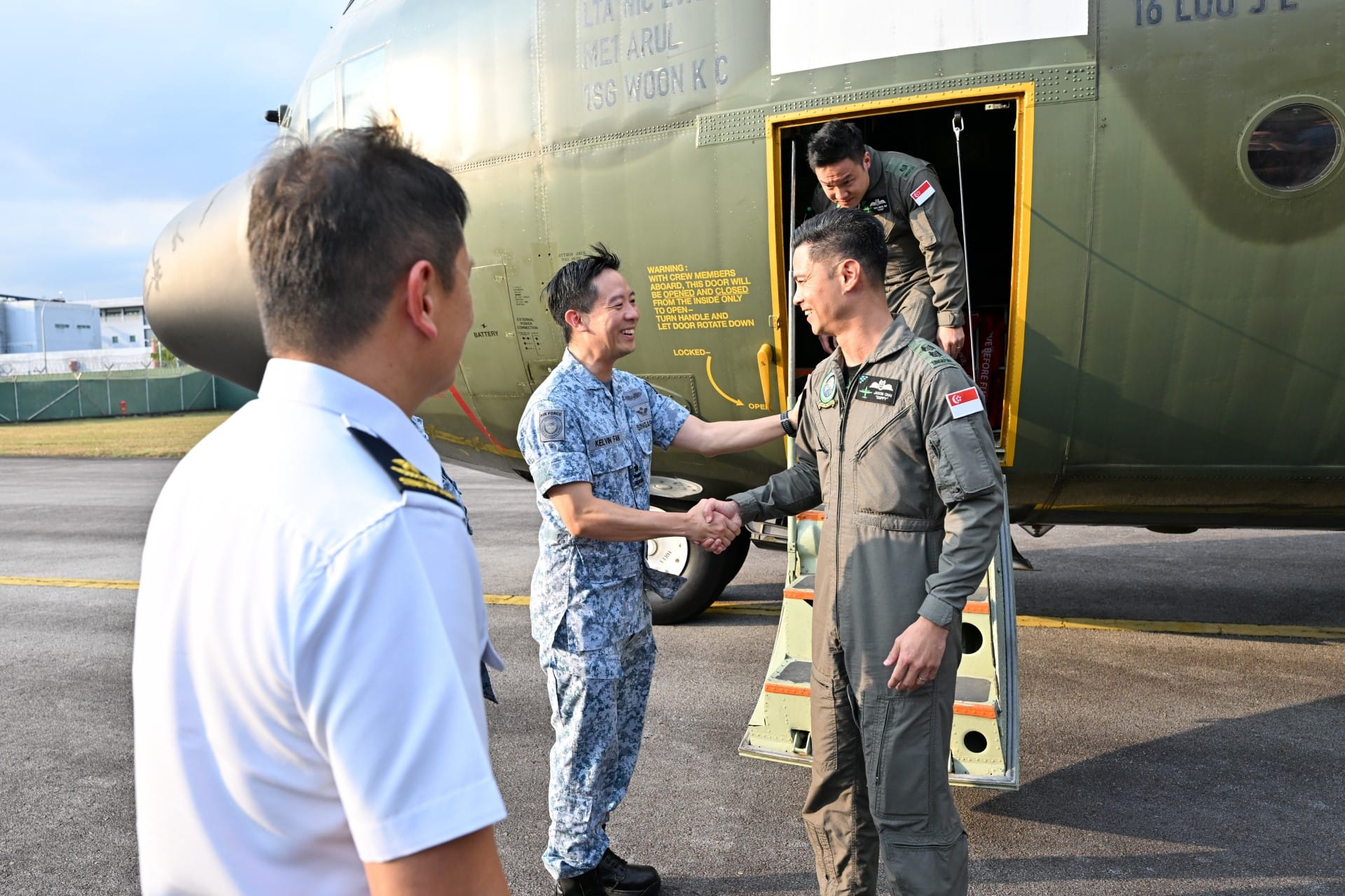 Chief of Air Force BG Kelvin Fan and senior officials from the Singapore Armed Forces receiving the C-130 crew at Paya Lebar Air Base.