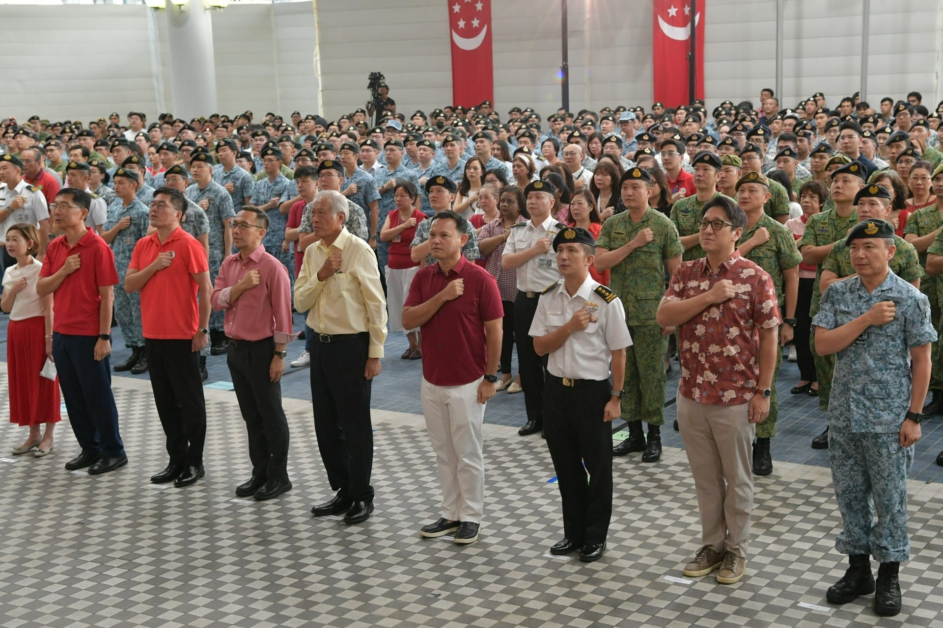 Minister for Defence Dr Ng Eng Hen (middle) leading personnel from the Ministry of Defence (MINDEF) and the Singapore Armed Forces (SAF) in the recitation of the National Pledge at the National Day Observance Ceremony (NDOC).