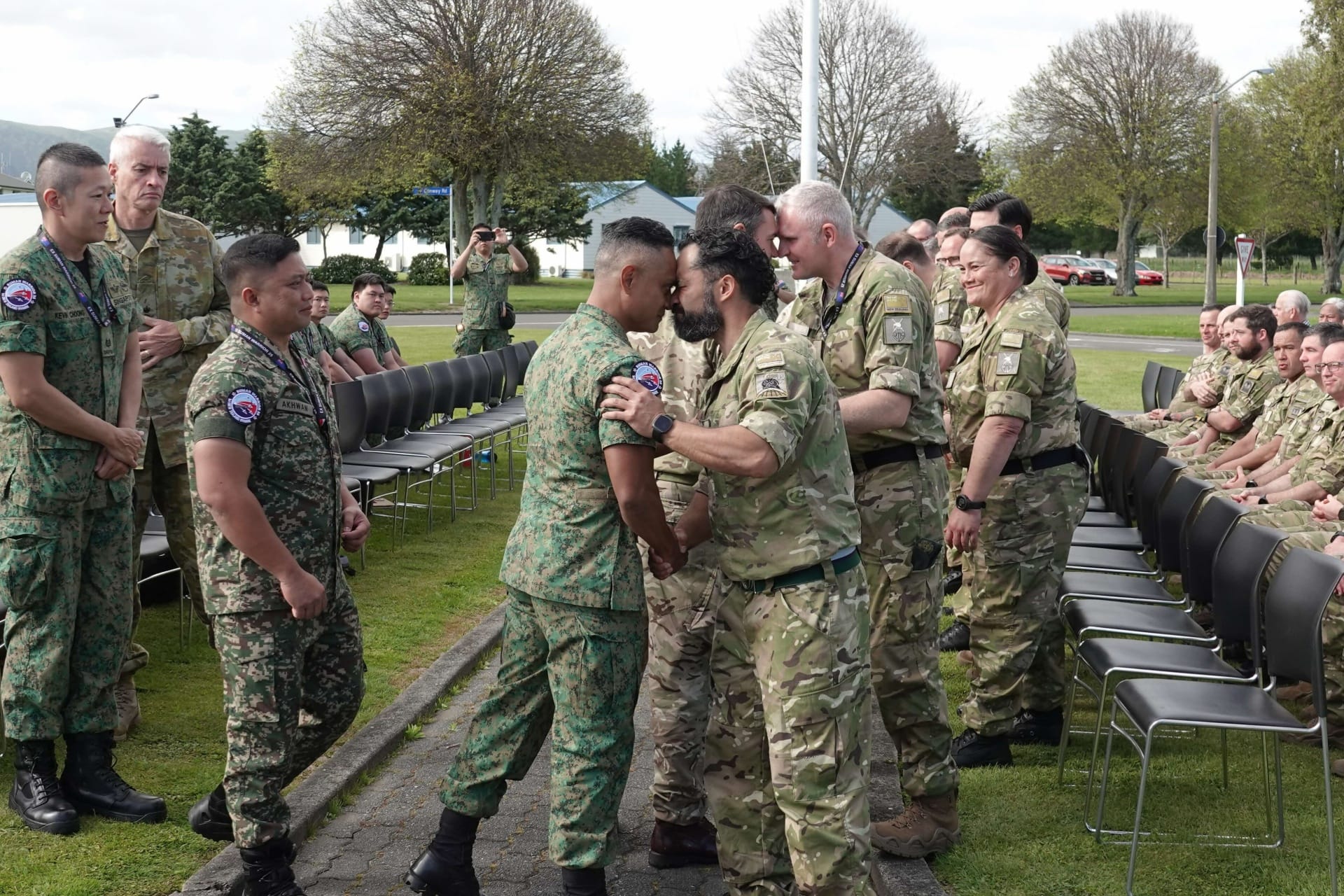 LTC Bani Faizal, Commanding Officer of the 730th Battalion, Singapore Guards (centre) exchanges the traditional Māori gr