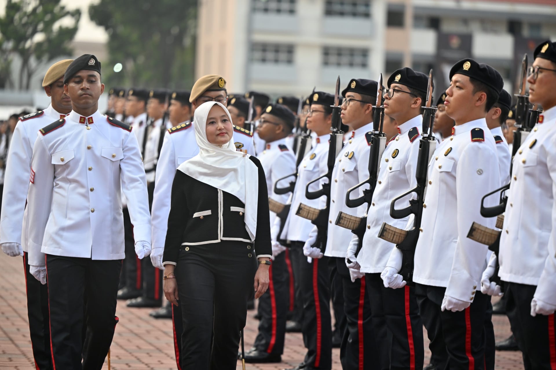 Minister of State for Digital Development and Information and for Health Rahayu Mahzam inspecting the contingents on parade at the 68th Specialist Cadet Graduation Parade.