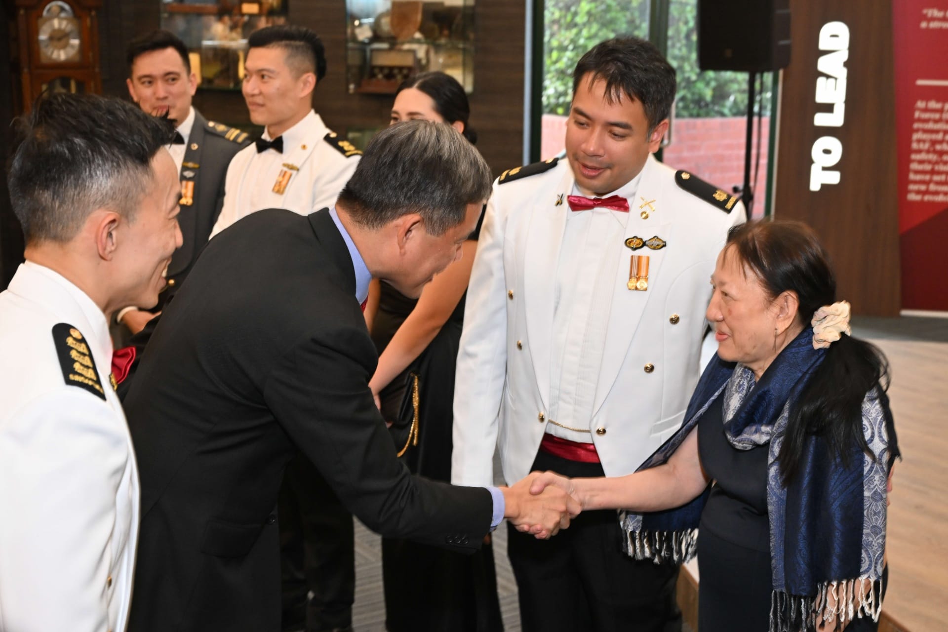 Minister for Defence Mr Chan Chun Sing interacting with the top graduates and their family members at the Goh Keng Swee
