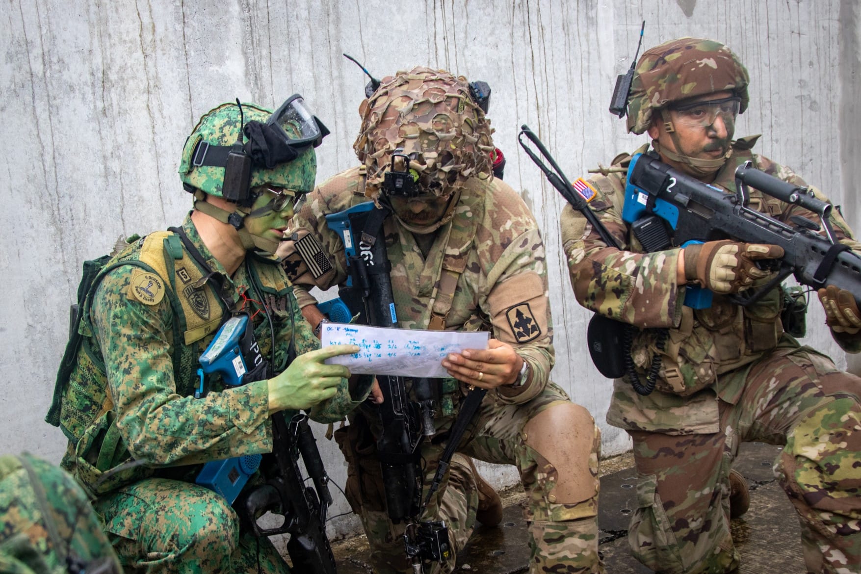Singapore & US Army soldiers coordinate in urban ops mission at SAFTI City.