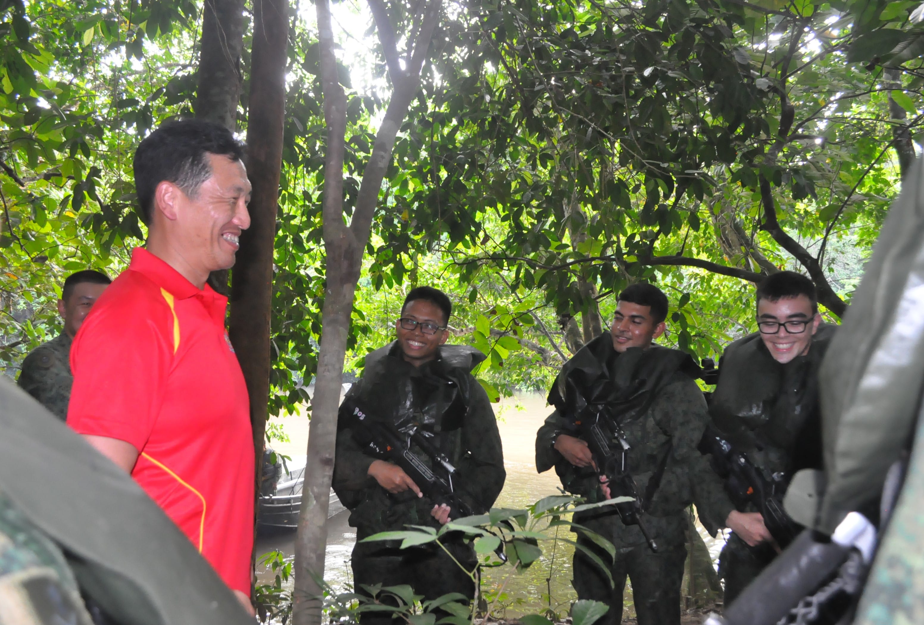 Second Minister for Defence Mr Ong Ye Kung interacting with Singapore Armed Forces (SAF) servicemen who had just completed a combat swim as part of their jungle confidence and survival training in Temburong, Brunei.