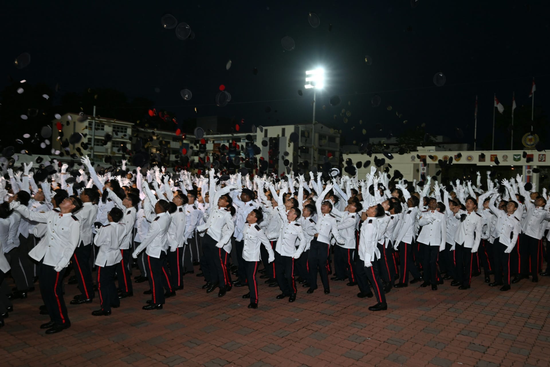 The Specialists and Military Experts tossing their headdresses at the end of the parade.