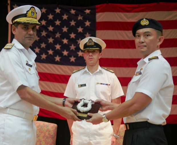 Rear-Admiral (RADM) Cheong Kwok Chien (right) taking over the command of CTF 151 from outgoing Commander RADM Zahid Ilyas (left), at the Change Of Command Ceremony in the presence of Deputy Commander, Combined Maritime Forces, Commodore Will Warrender.