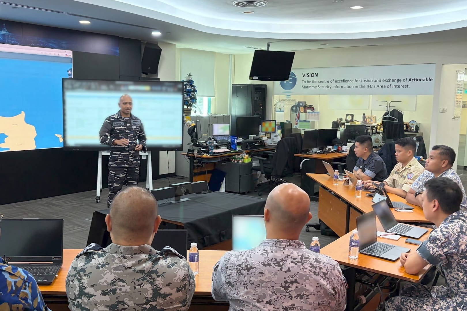 Information Fusion Centre’s International Liaison Officers conducting operational briefings in support of the Search and Rescue Exercise at sea.