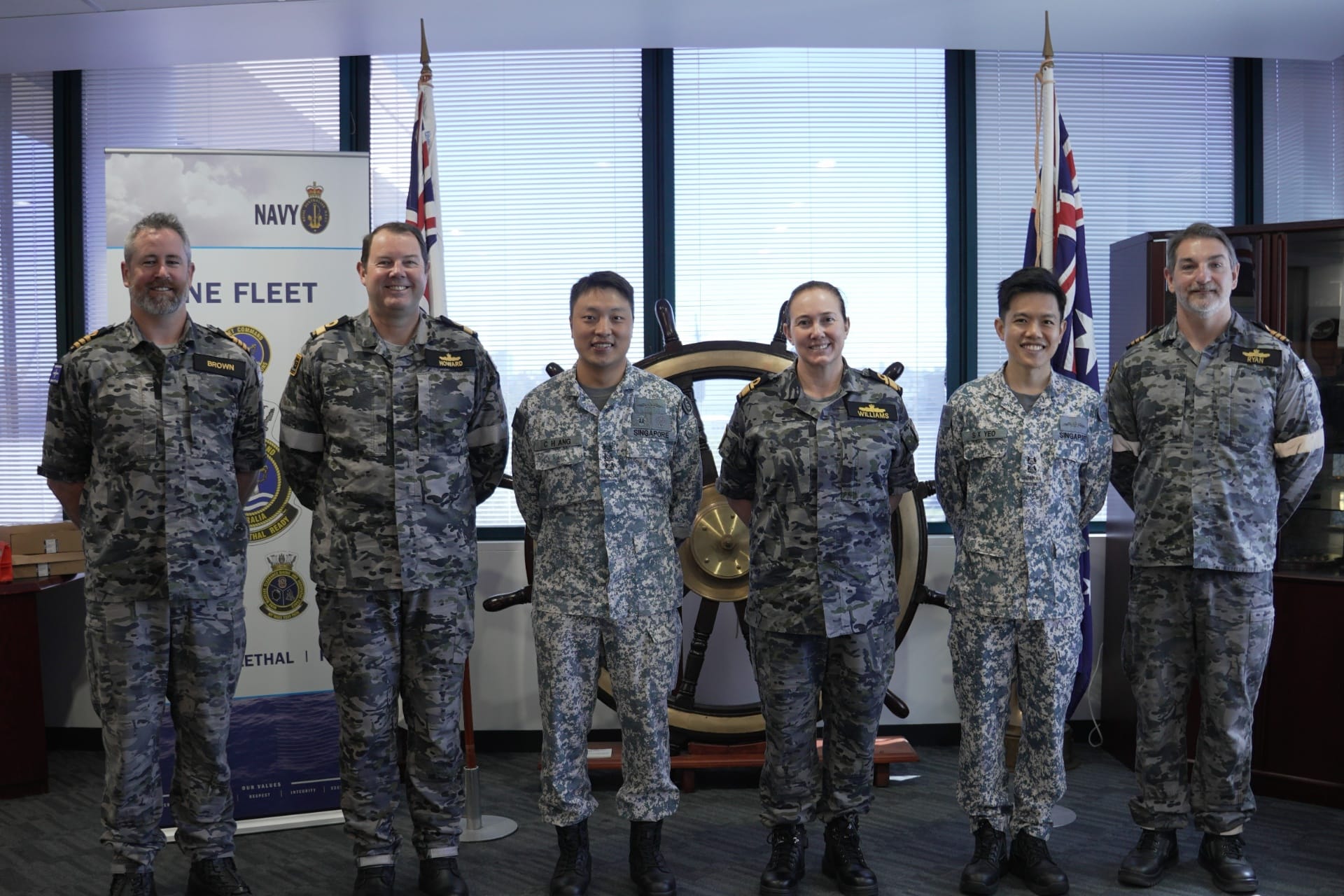 Republic of Singapore Navy (RSN) Fleet Commander Colonel Bertram Ang (third from left) at the Opening Ceremony of Exercise Singaroo, with Commander Australian Fleet Rear Admiral Anita Williams (third from right) and representatives from the RSN and the Royal Australian Navy (RAN).