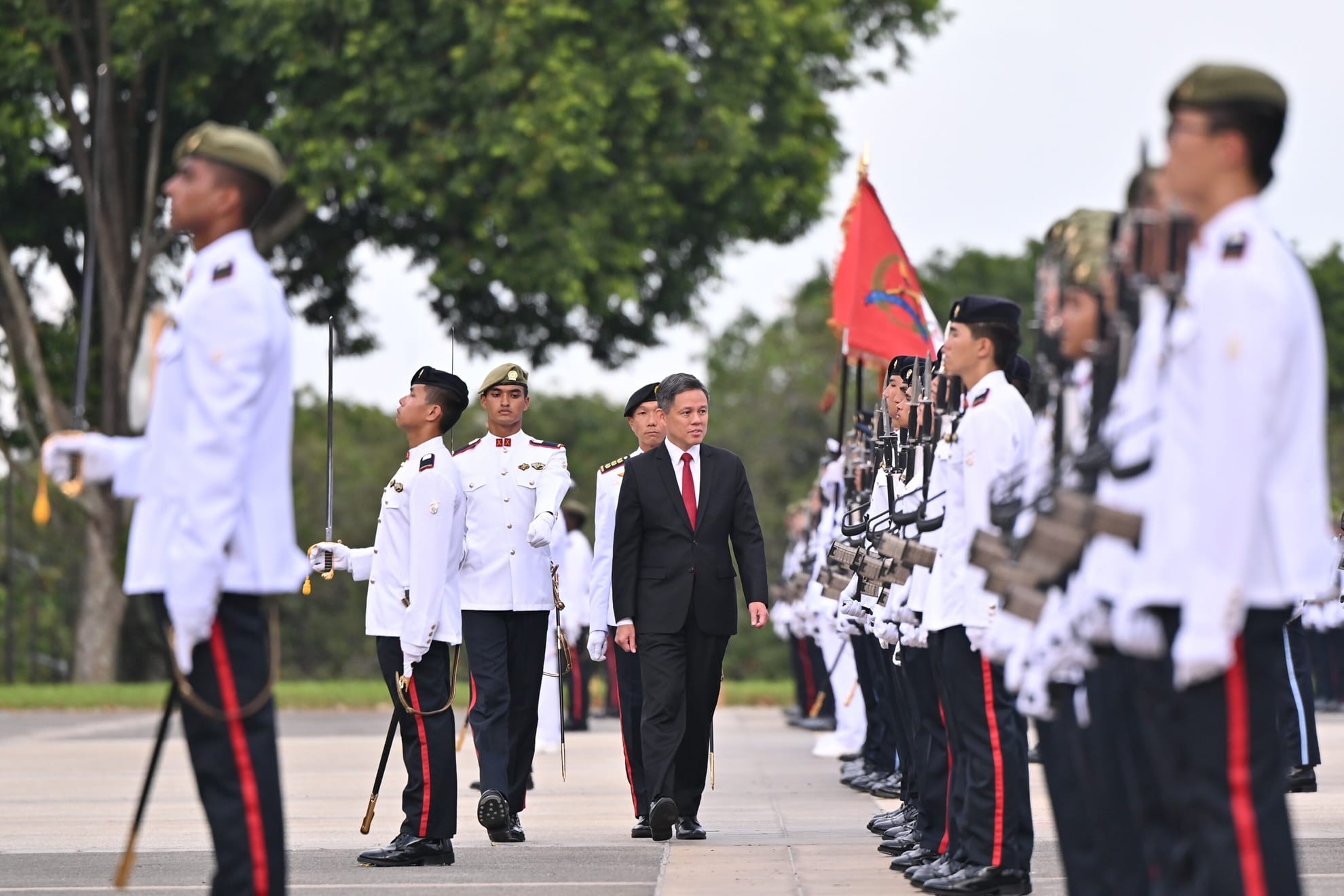 Minister for Defence, Mr Chan Chun Sing, reviewing the contingents at the 140th Officer Cadet Commissioning Parade this evening.
