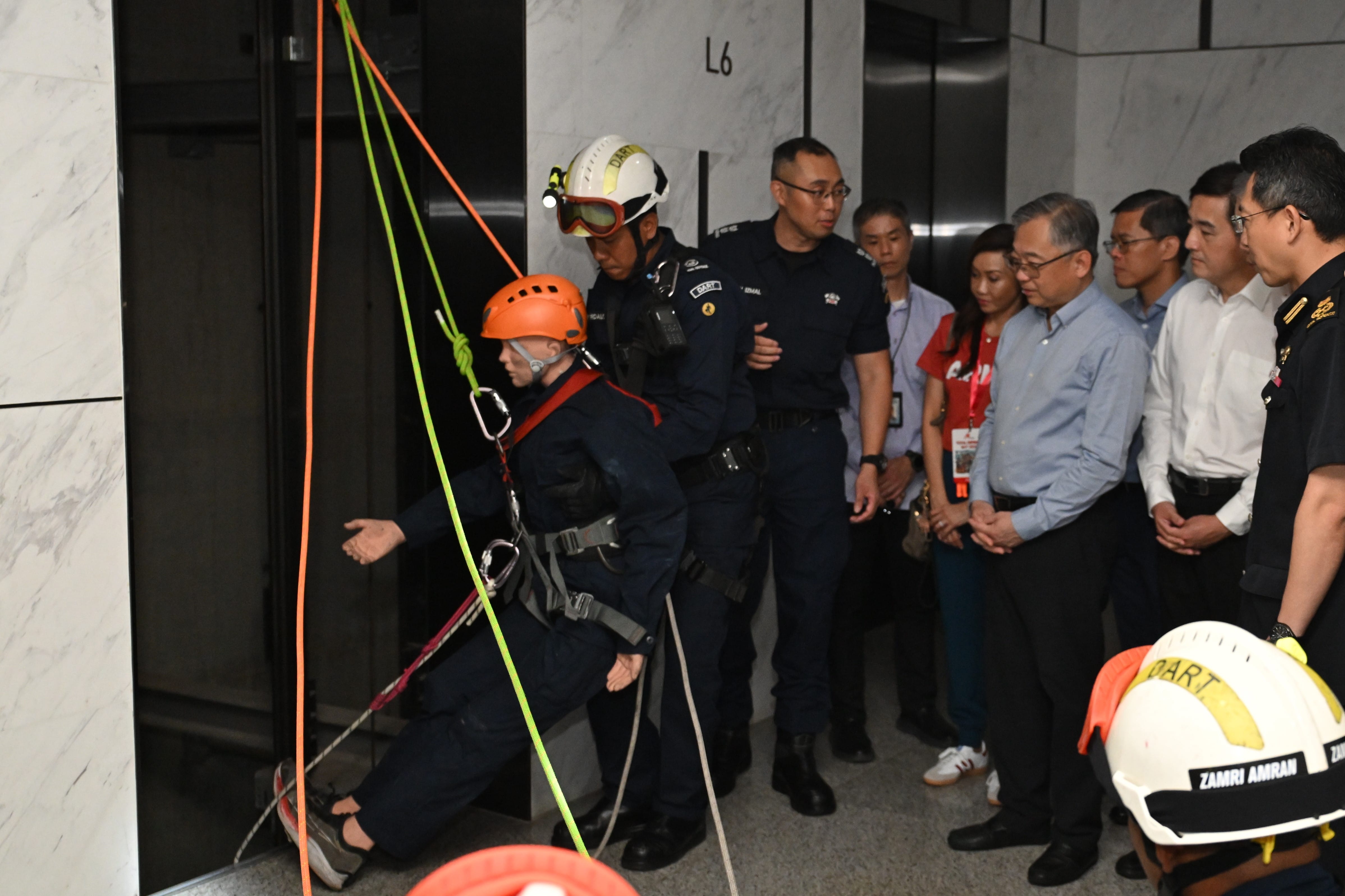 A Singapore Civil Defence Force (SCDF) representative explaining SCDF’s lift rescue capabilities to DPM Gan. 