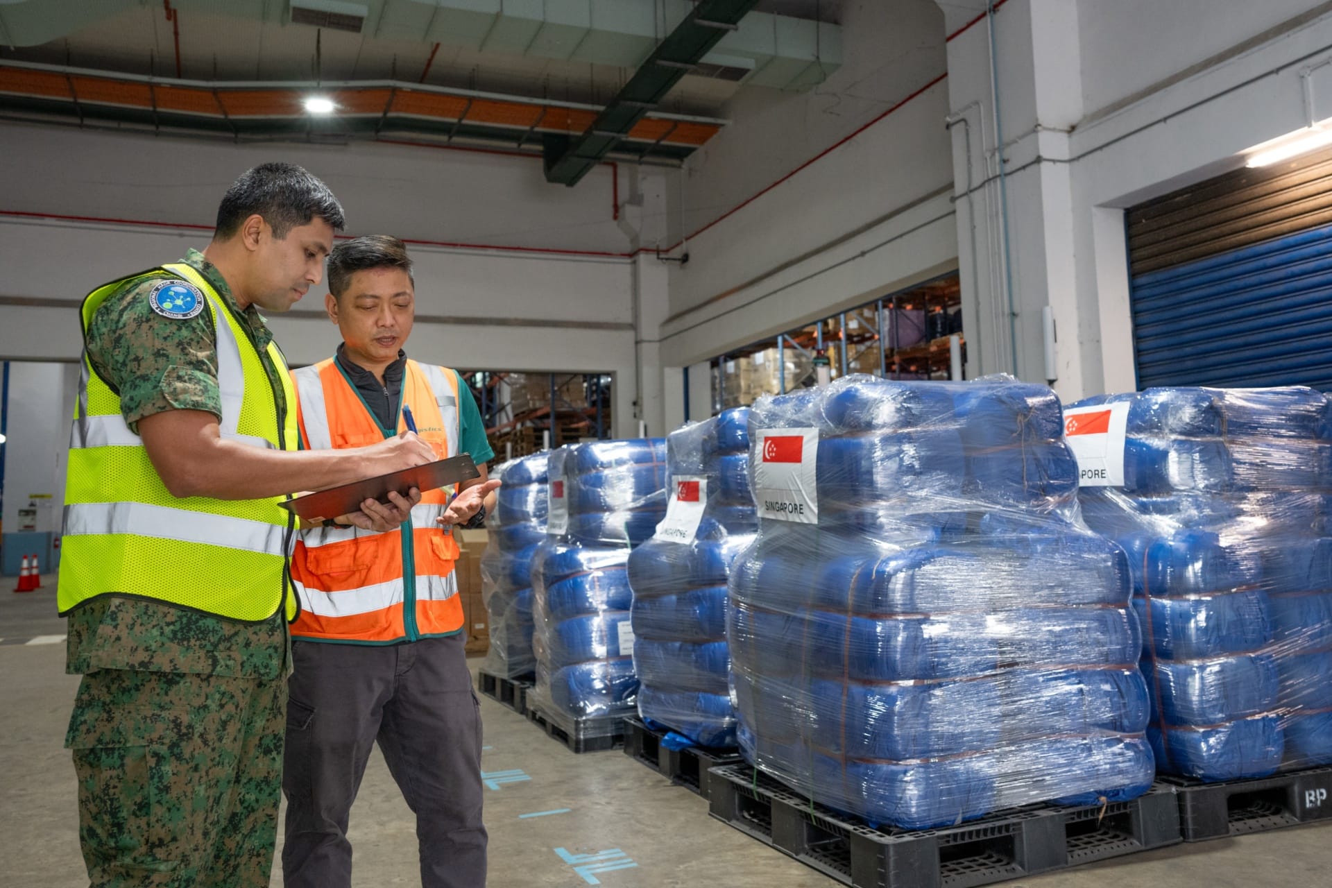 Personnel from the Singapore Armed Forces’ (SAF) Changi Regional HADR Coordination Centre (RHCC) taking stock of the SAF
