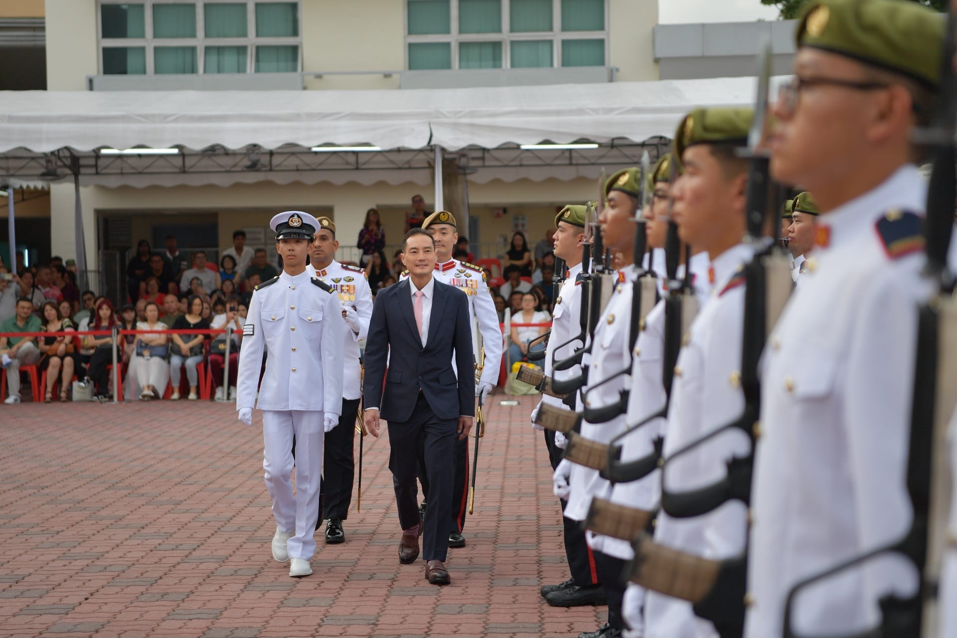 Senior Minister of State, Ministry of Digital Development and Information and Ministry of Health, Mr Tan Kiat How inspecting the contingents on parade at the 66th Specialist Cadet Graduation Parade.