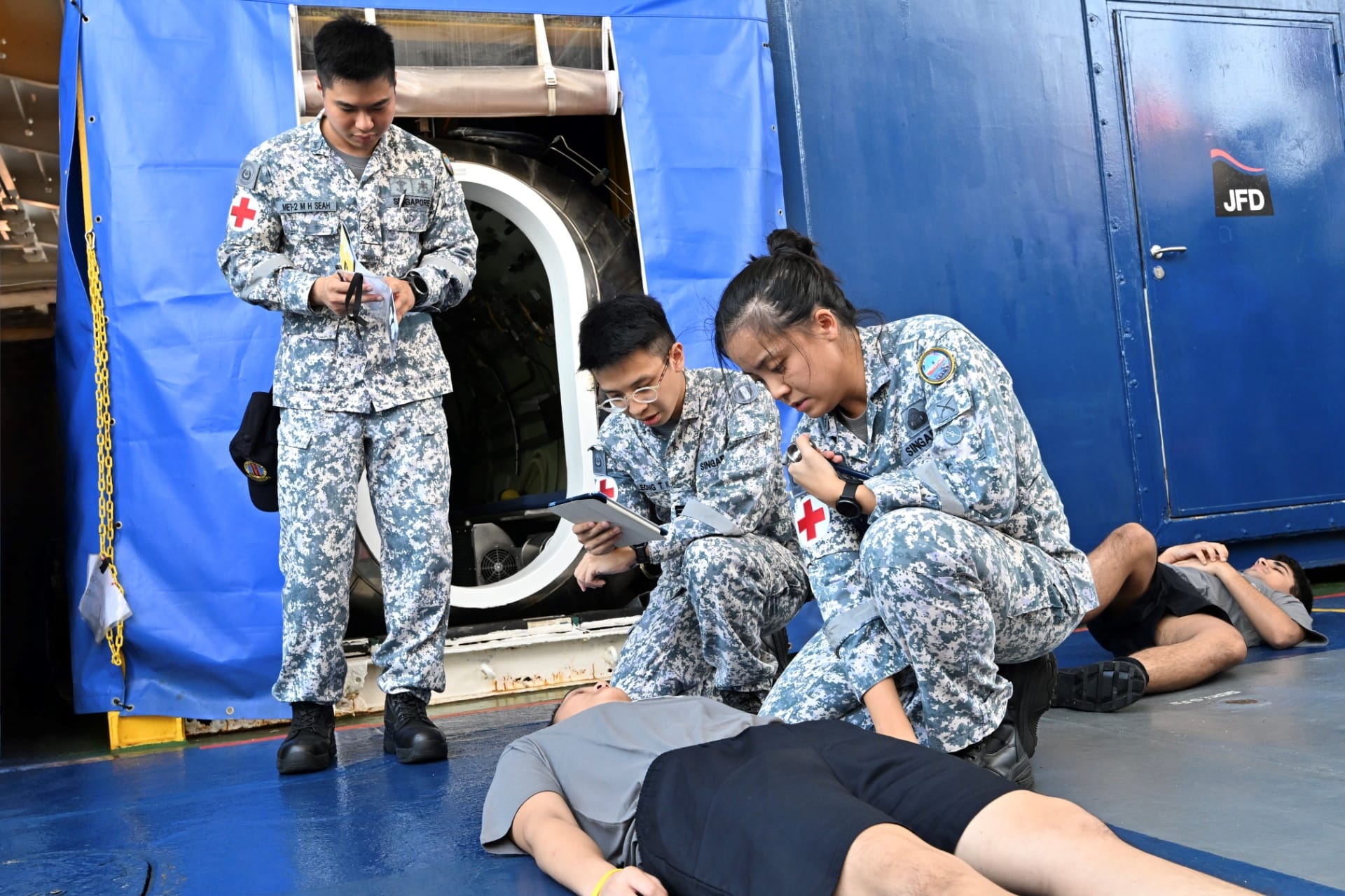 RSN medical personnel attending to a simulated injured personnel as part of the exercise conduct.