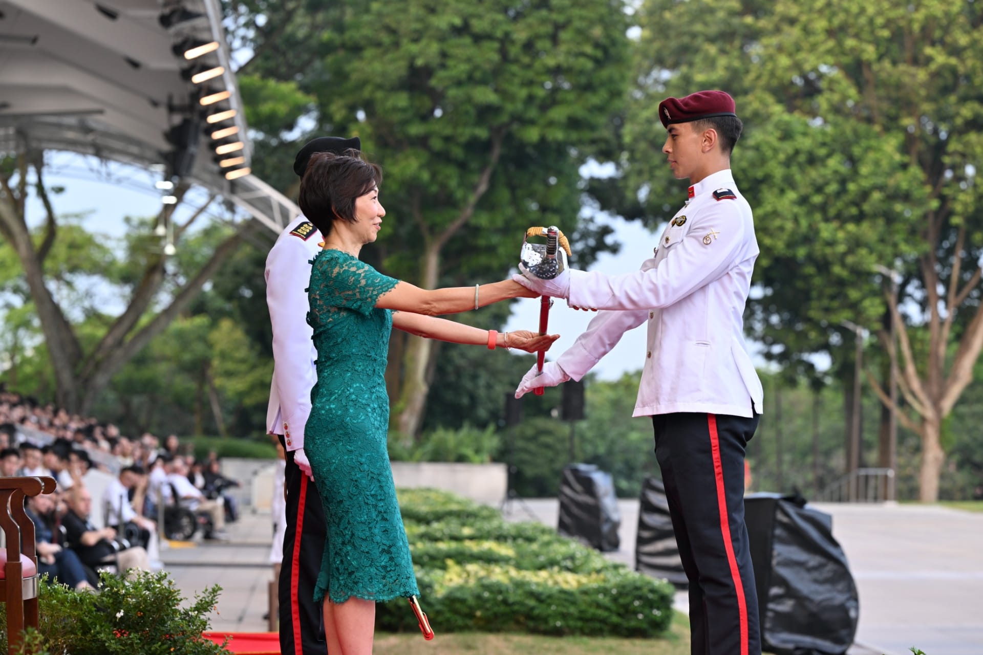 Ms Grace Fu presenting the Sword of Honour to Second Lieutenant (2LT) Adam Ari Brest, from the Singapore Army.