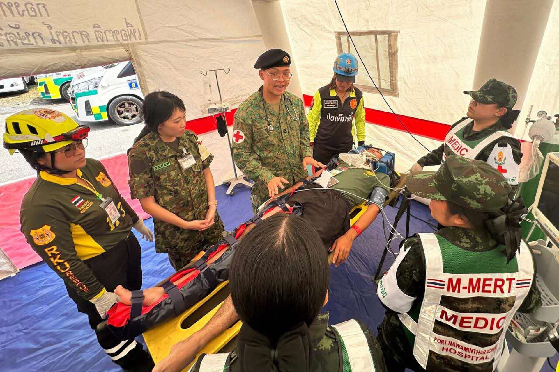 Captain (DR) Ang Ding Neng, Medical Officer, directing the multilateral team during the Humanitarian Assistance and Disaster Relief demonstration.