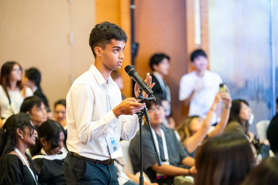 An attendee asking questions in front of a mic.