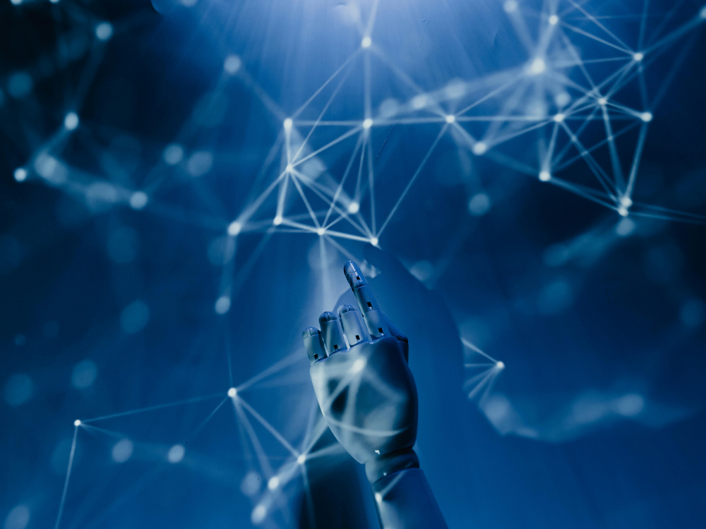 Robotic hand reaching toward glowing data nodes on a futuristic blue network background