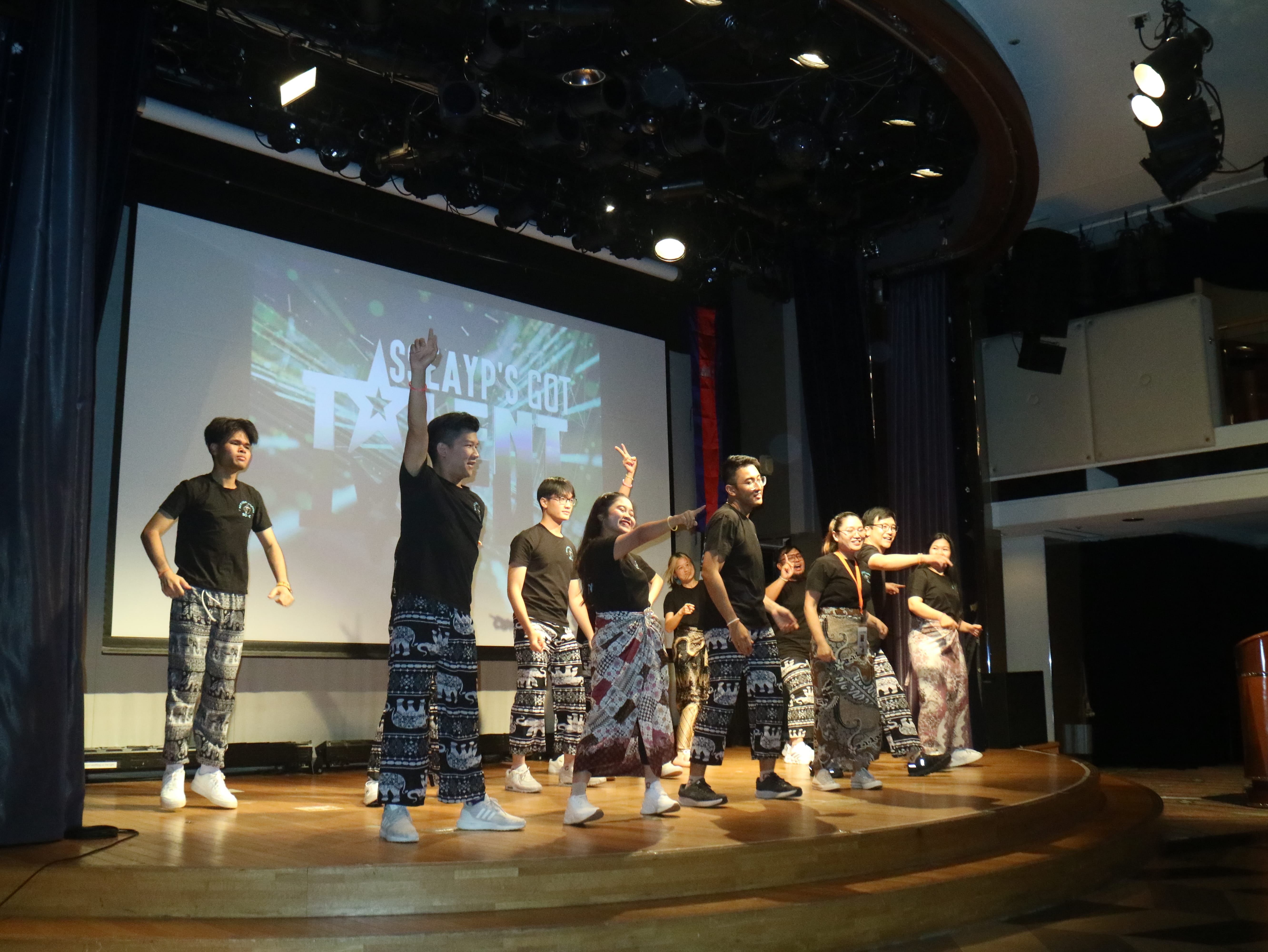 A group of participants performing on stage with a screen projecting the words "SSEAYP's got talent".