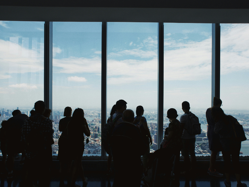silhouette of people at a large window