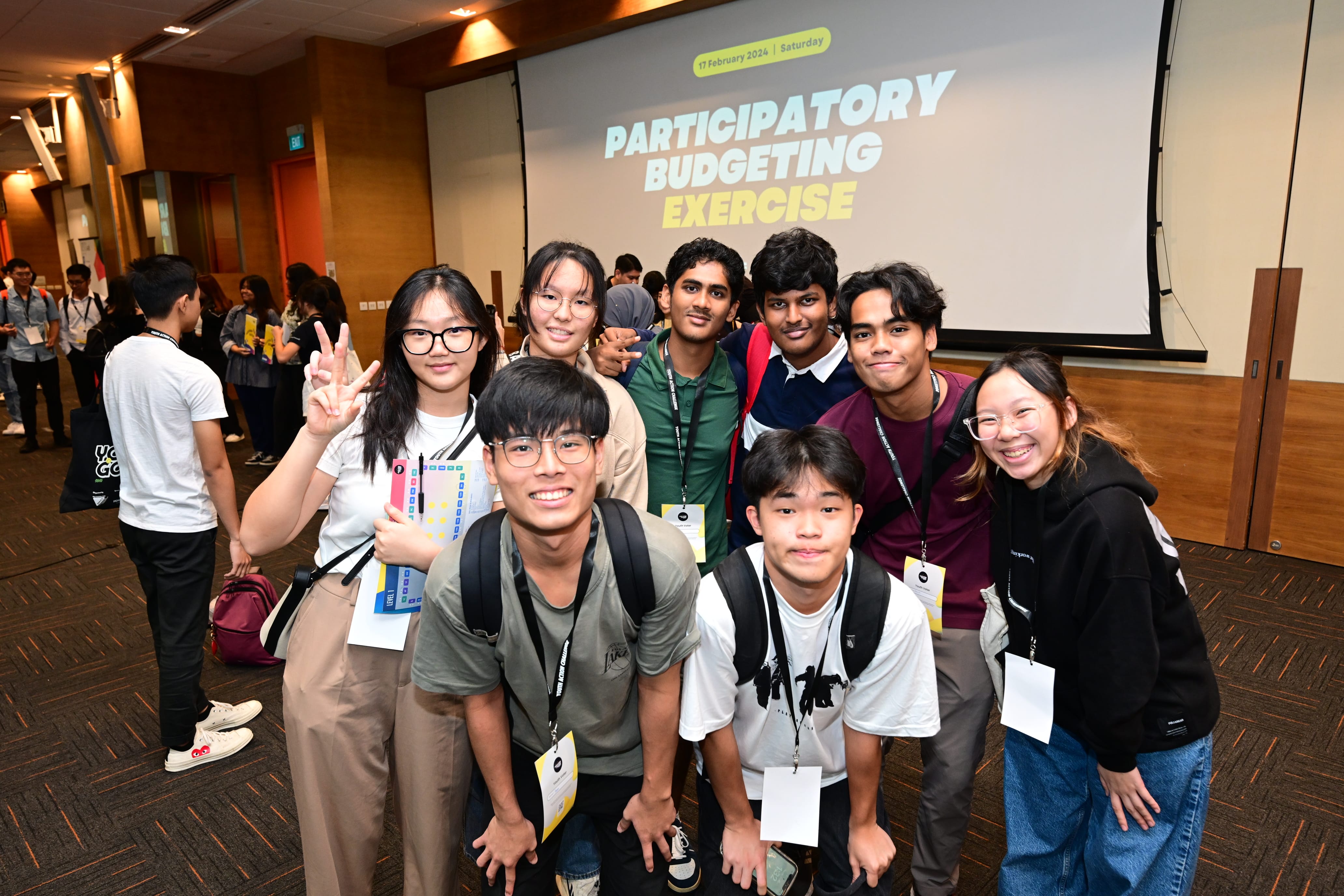 Group of young people in front of screen reading "Participatory Budgeting Exercise".