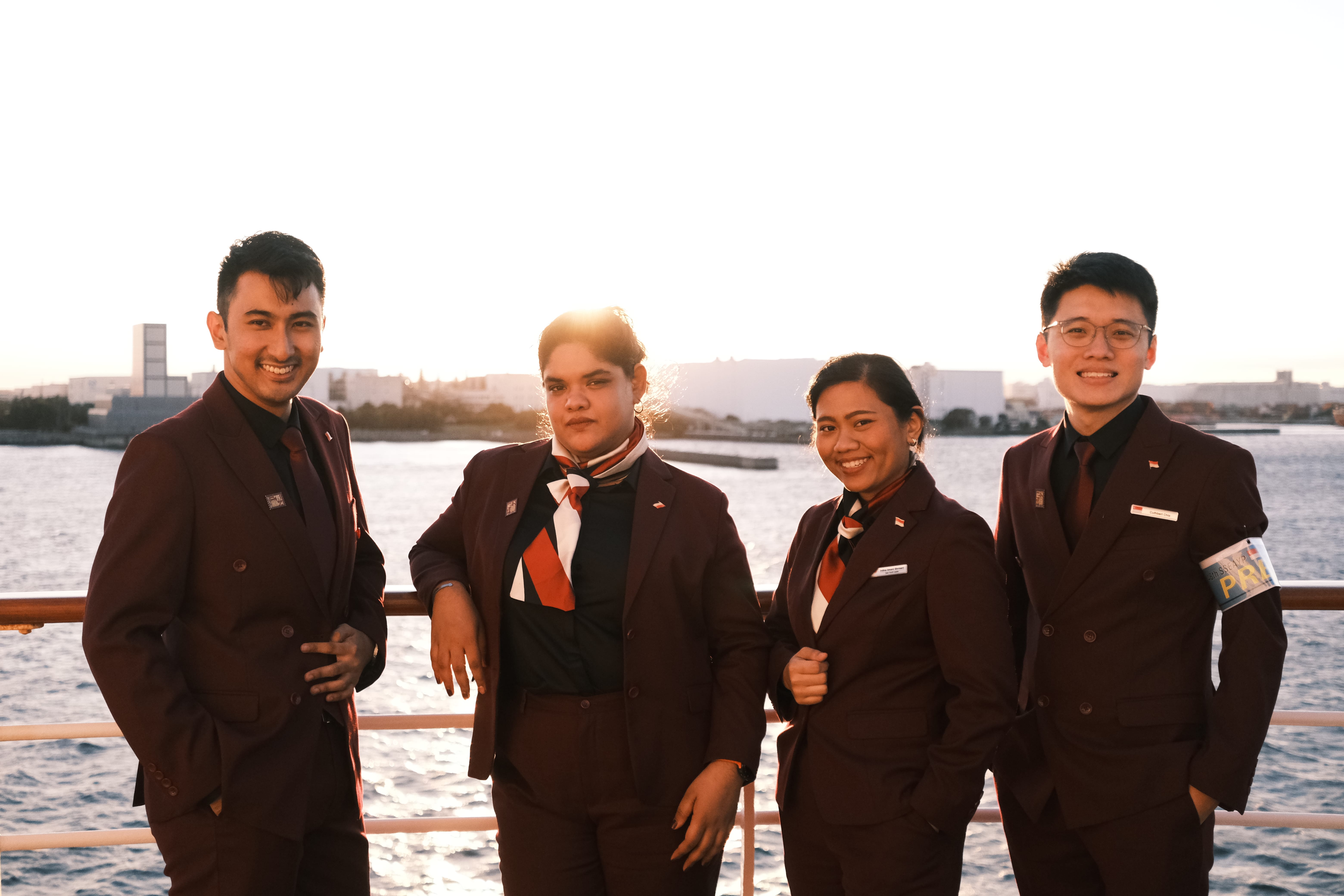 A close-up shot of two ladies and two men in red suits on the cruise.