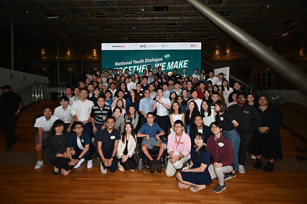Large group poses at 'National Youth Dialogue' event with the Forward2030 and MCCY logos.