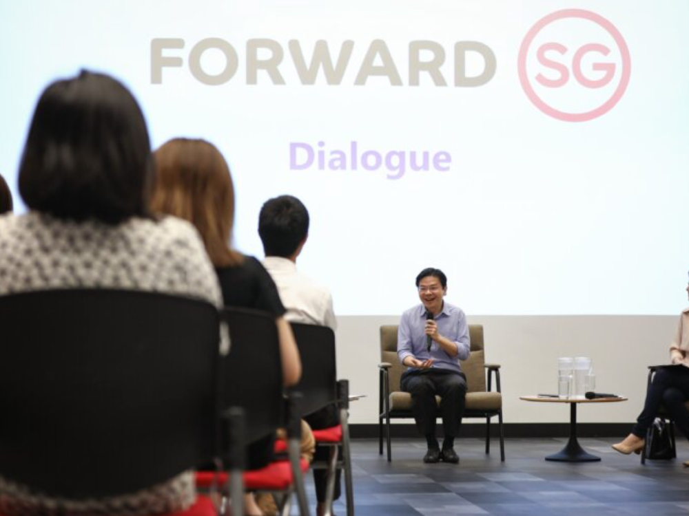 Lawrence Wong speaking at a Forward SG dialogue session with seated participants in foreground