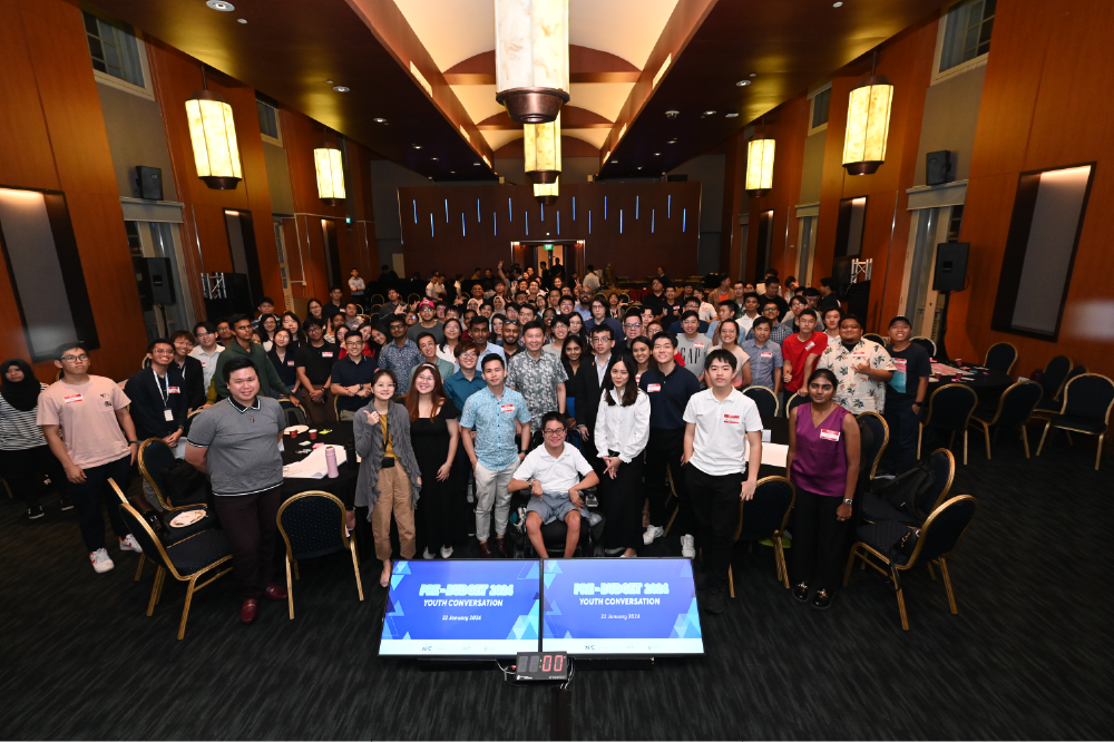 Large group of people in a room for a group photo