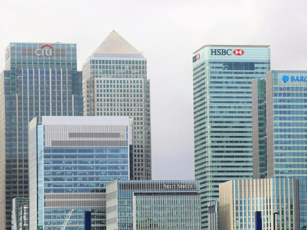 Cityscape with the logos of Citi, HSBC, Barclays, and State Street on tall buildings.