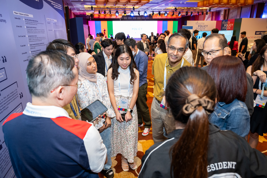 Attendees gathering in a circle having a discussion.