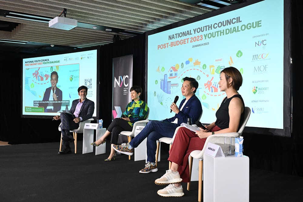 Four people seated on stage during a National Youth Council "Post-Budget 2023" youth dialogue.